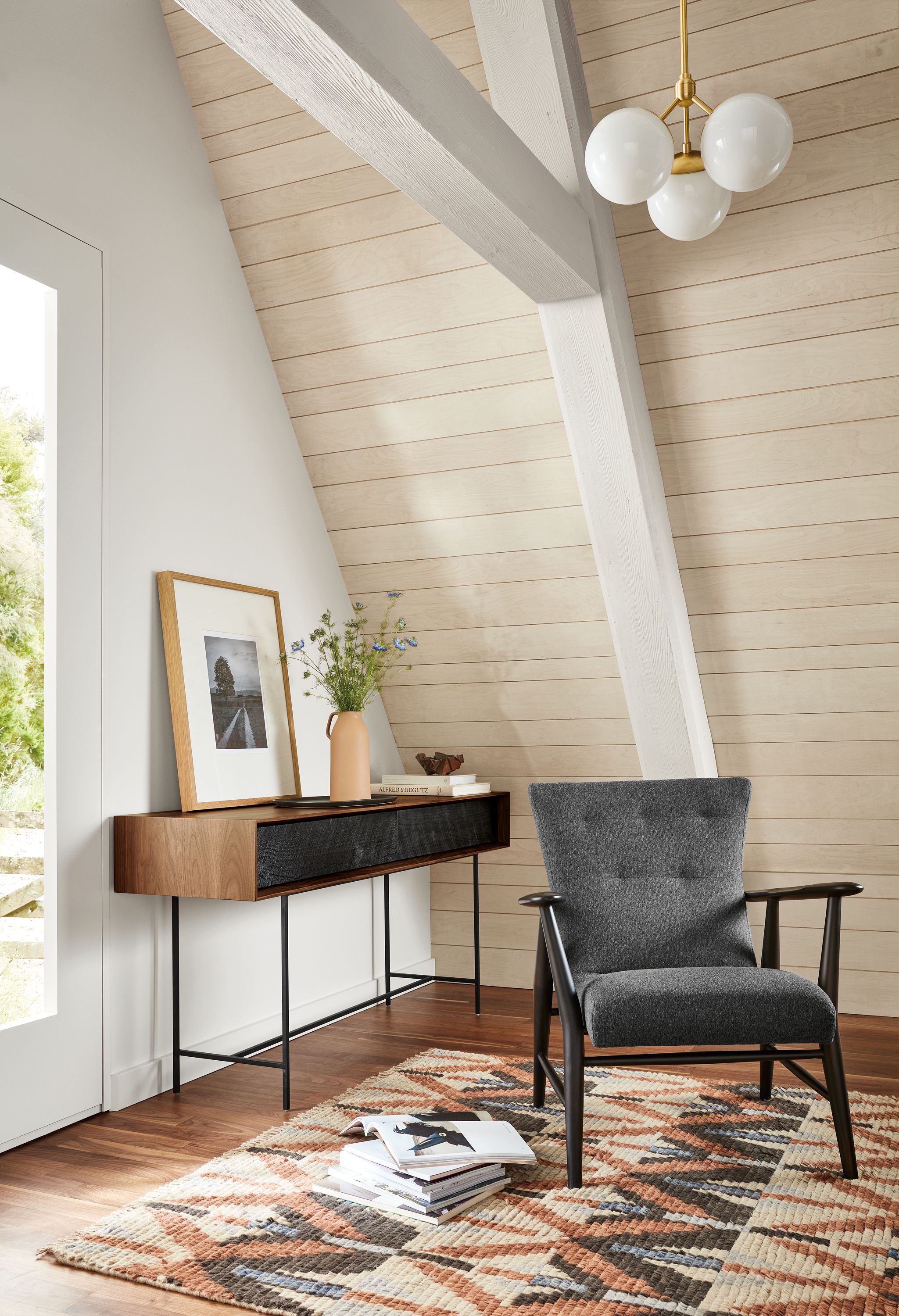 Room setting with Jonas Lounge Chair in Flint Fabric, McKean 60-wide Reclaimed Wood Console Table in Walnut with Charcoal.