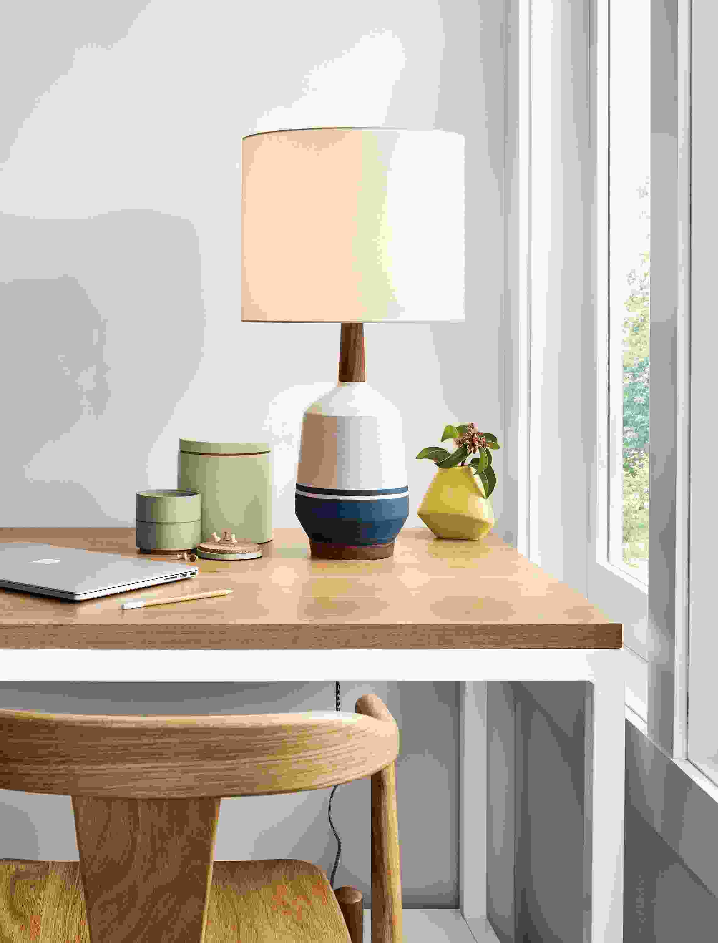 Close-up of a Meriden Table Lamp on a Pratt Narrow Shelf Counter Tablewith an Evan Counter Wood Stool.