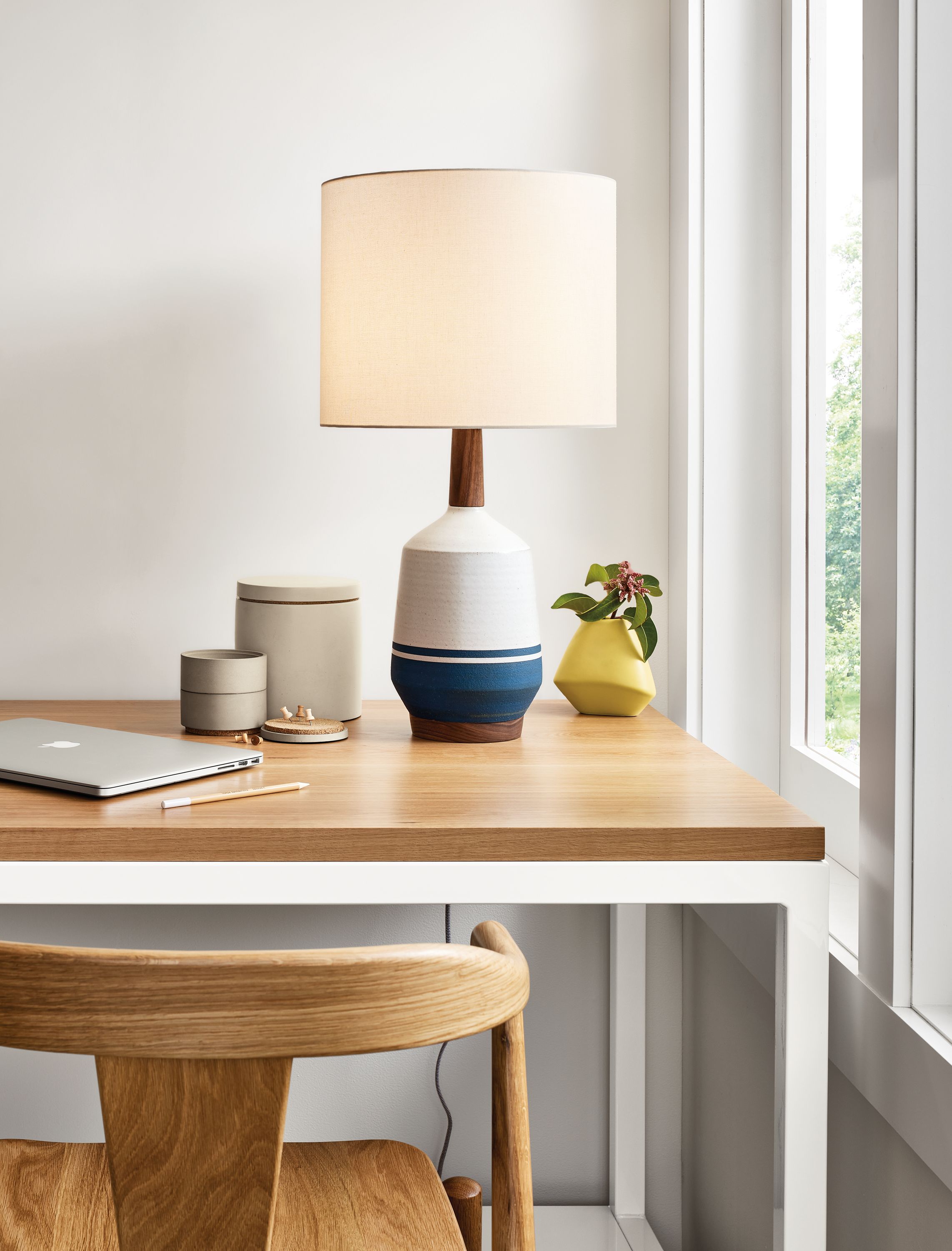 Close-up of a Meriden Table Lamp on a Pratt Narrow Shelf Counter Tablewith an Evan Counter Wood Stool.