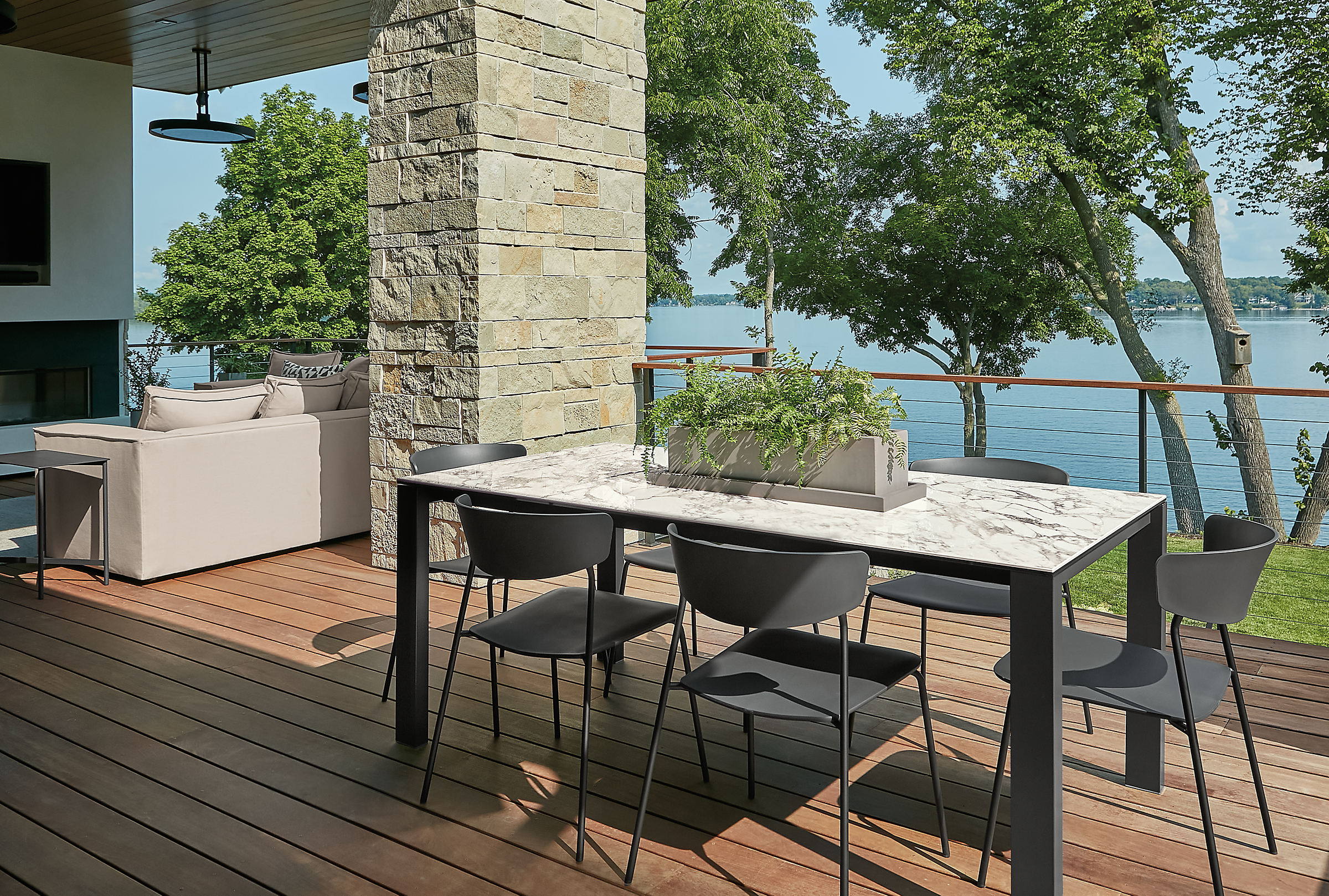 Outdoor space with metric outdoor extension table and six wolfgang dining chairs.