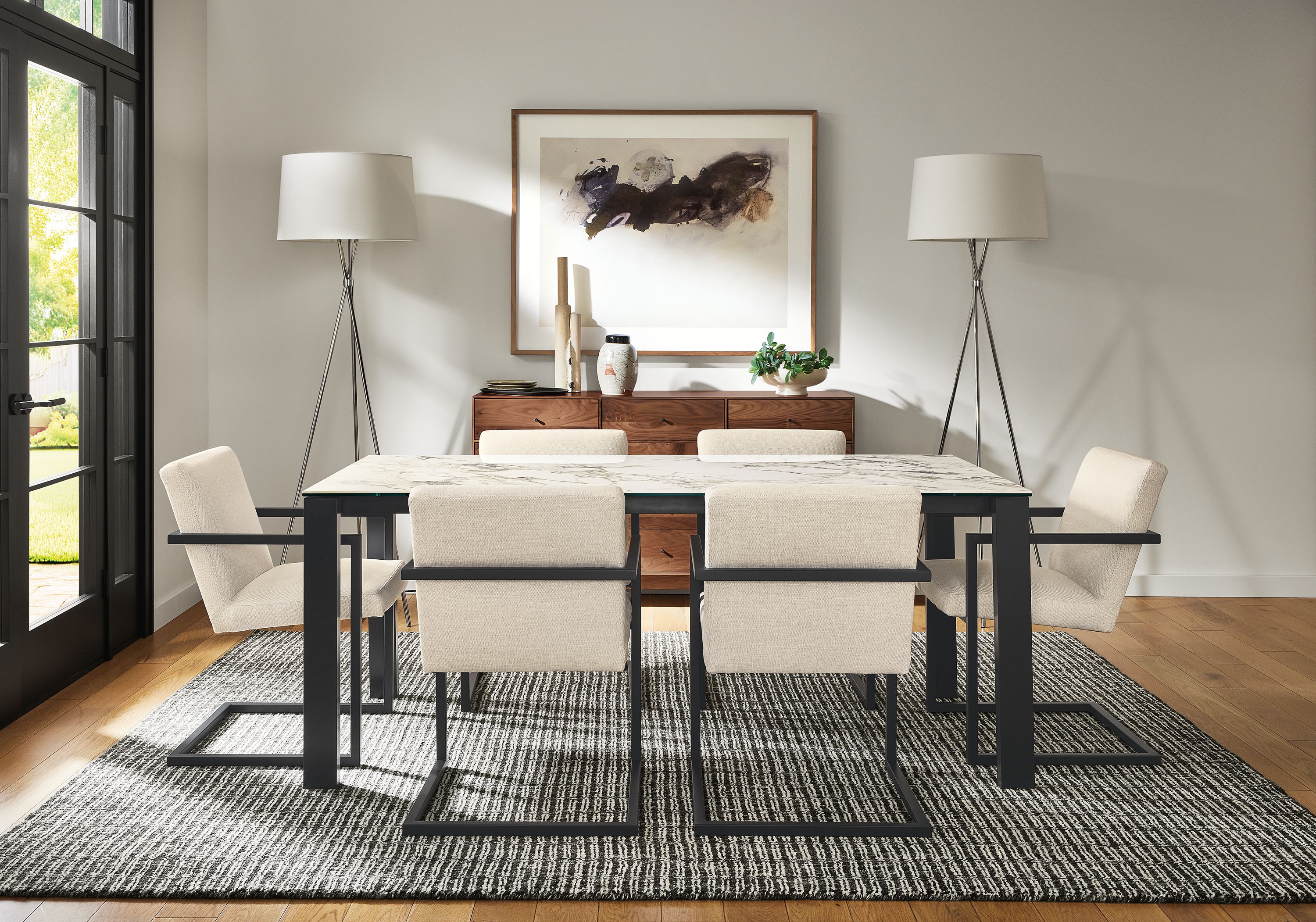 Dining room with Metric 72-wide extension table in with marbled bright white ceramic top, Lira arm chair in Sumner Ivory.