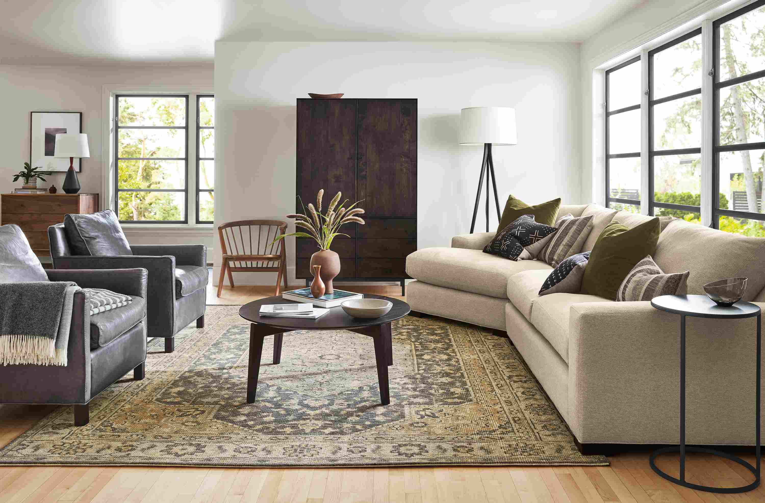 Living room with Metro sofa in Tatum Oatmeal, Bram leather chairs, Orlin coffee table and Veda rug in smoke.