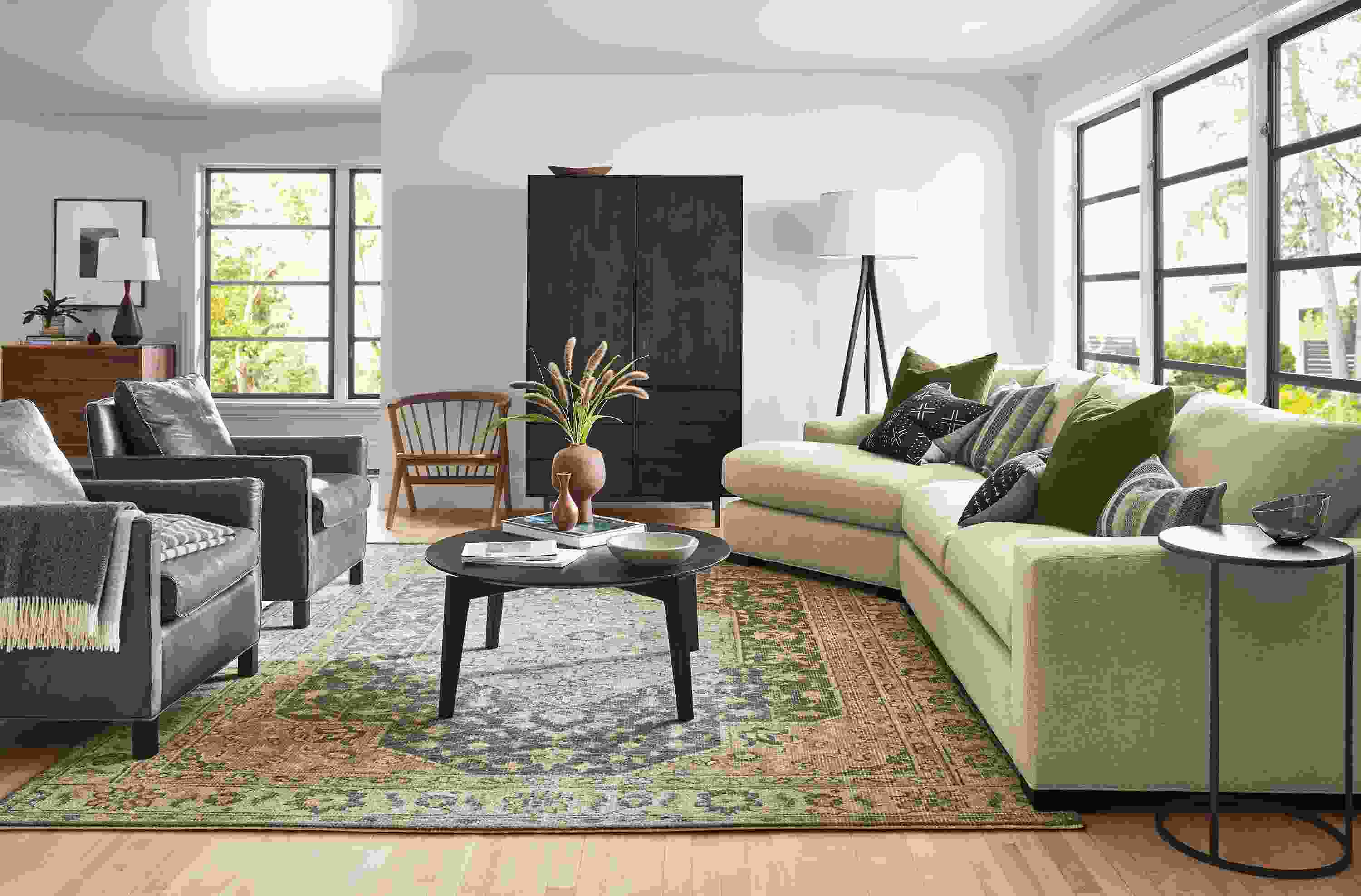 Living room with Metro sofa in Tatum Oatmeal, Bram leather chairs, Orlin coffee table and Veda rug in smoke.