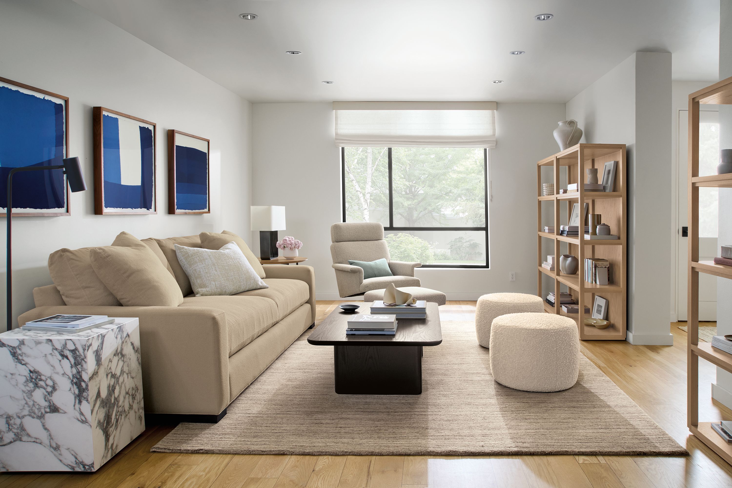 Living room with Metro deep 98-wide sofa in Declan Camel, Carver coffee table in charcoal on oak and Nomad rug in stone.