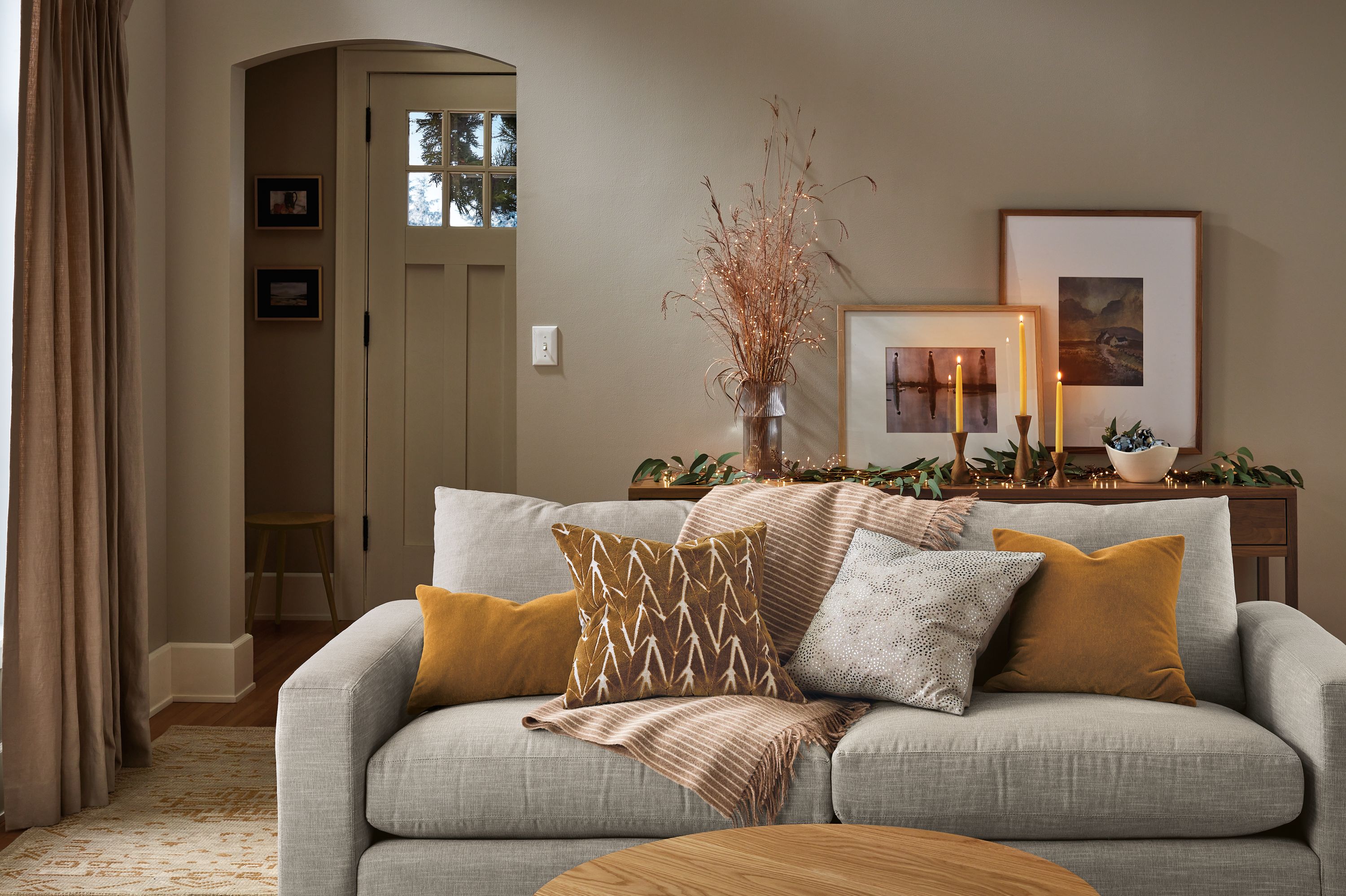 living room with metro sofa, branch pillow, jiji pillow, norton throw.