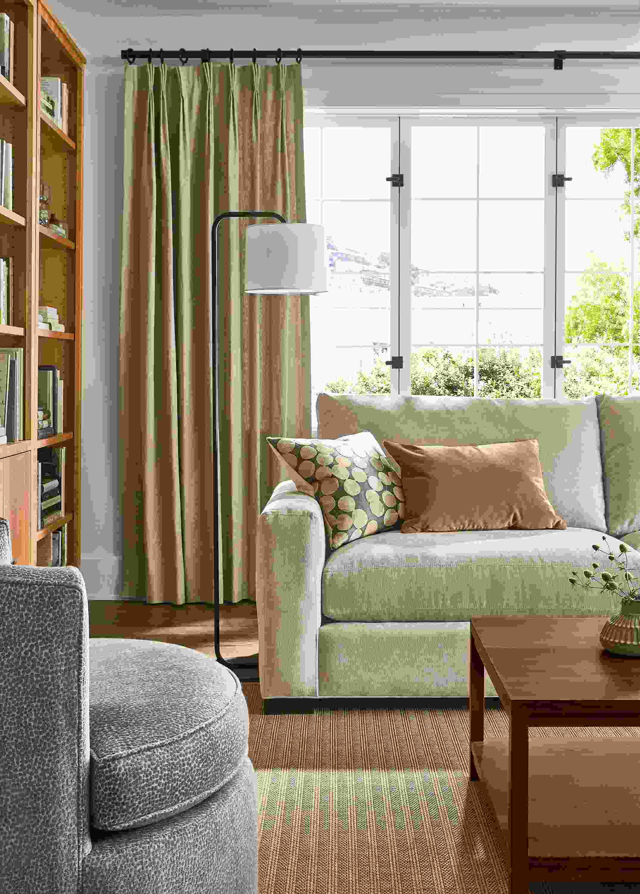 Living room with metro 88-wide sofa in mori oatmeal, otis swivel chair in faron cadet and leland 8 by 10 rug in sand.