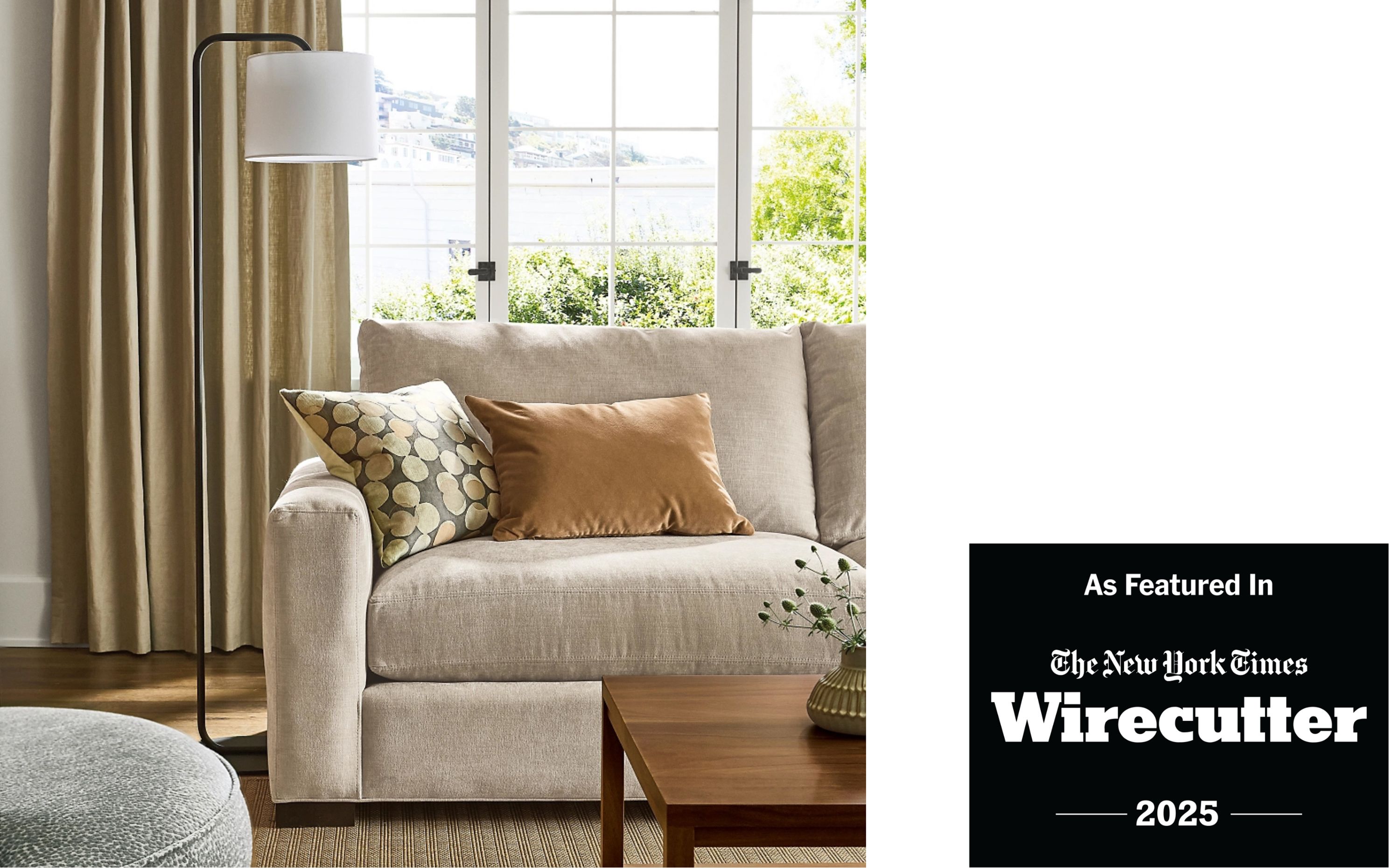 AS featured in The New York Times Wirecutter 2024. Living room with metro 88-wide sofa in mori oatmeal, otis swivel chair in faron cadet and leland 8 by 10 rug in sand.