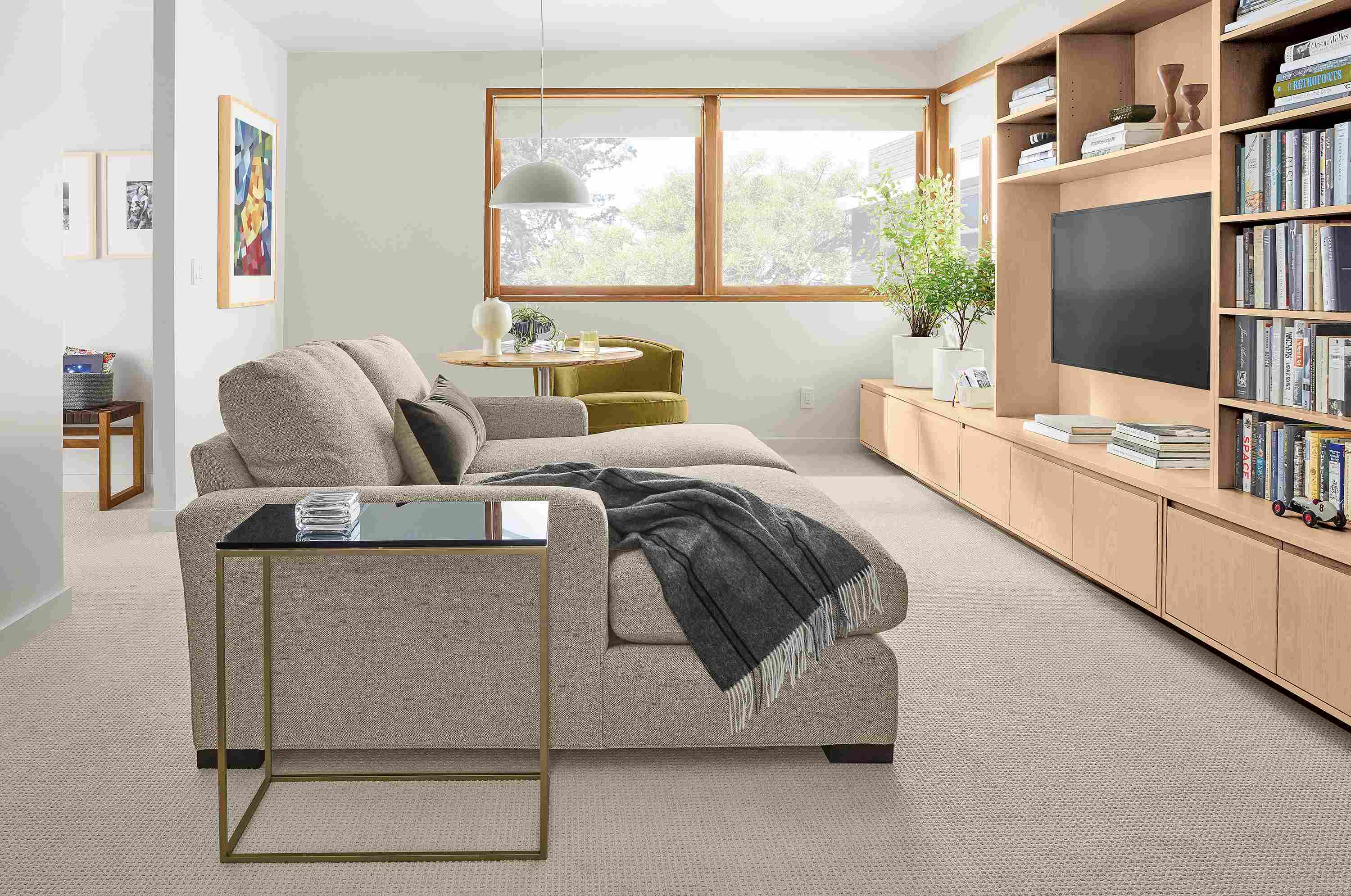 Living room with Metro double chaise sectional and keaton bookcases and media cabinet in salt on red oak.