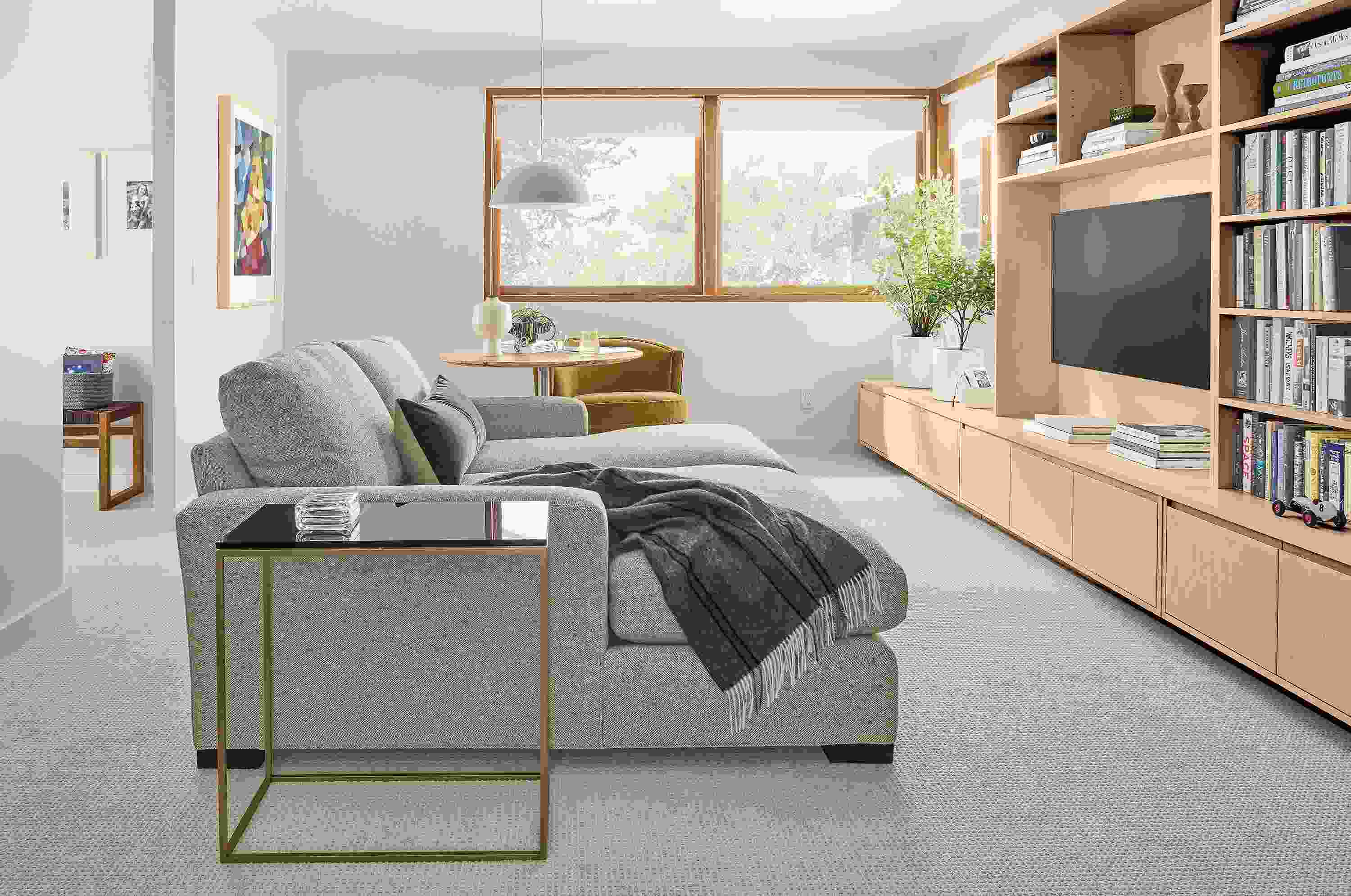 Living room with Metro double chaise sectional and keaton bookcases and media cabinet in salt on red oak.