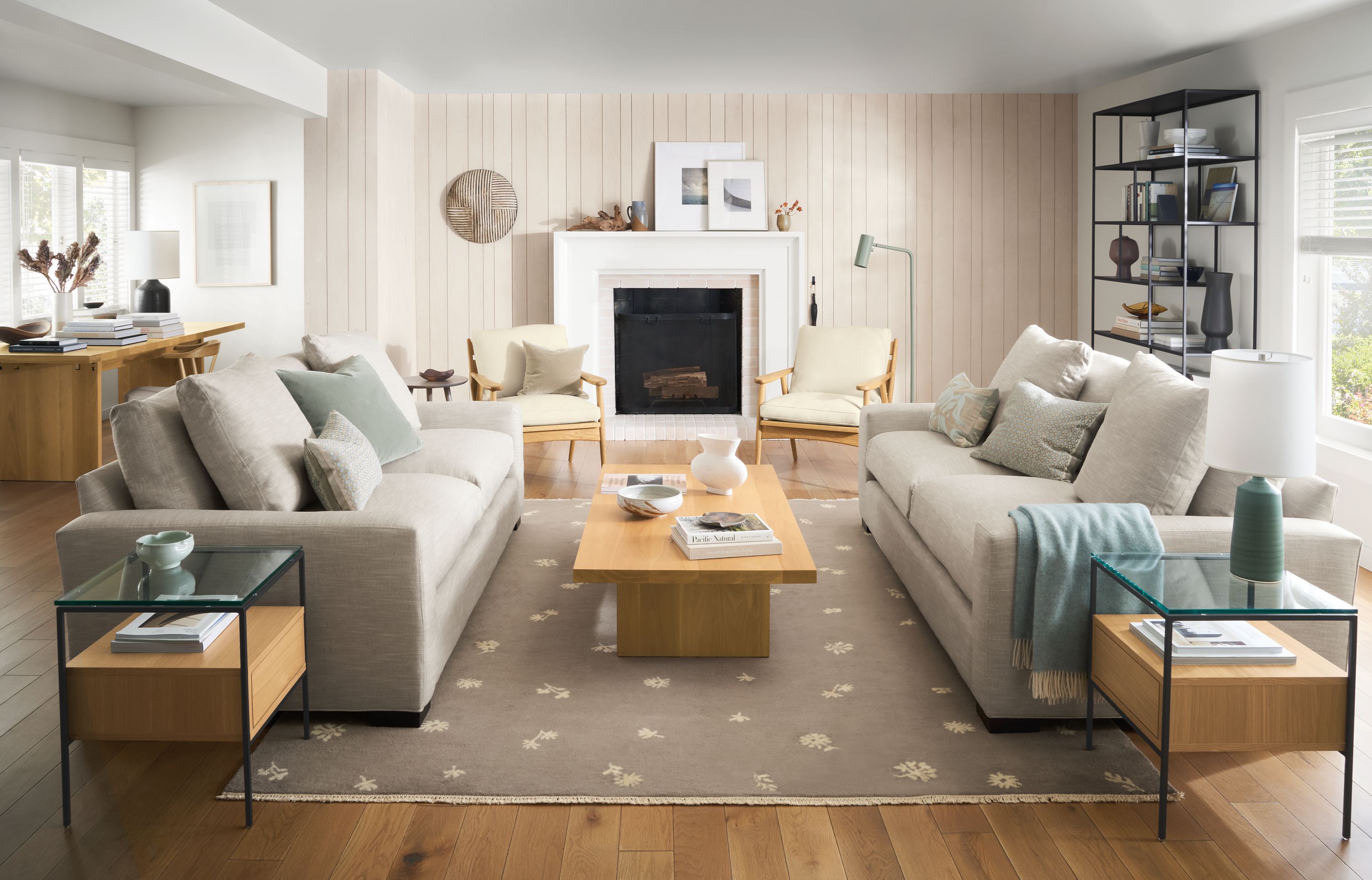 living room with fireplace, ericson chairs, metro sofas, tansy rug, corbett coffee table.