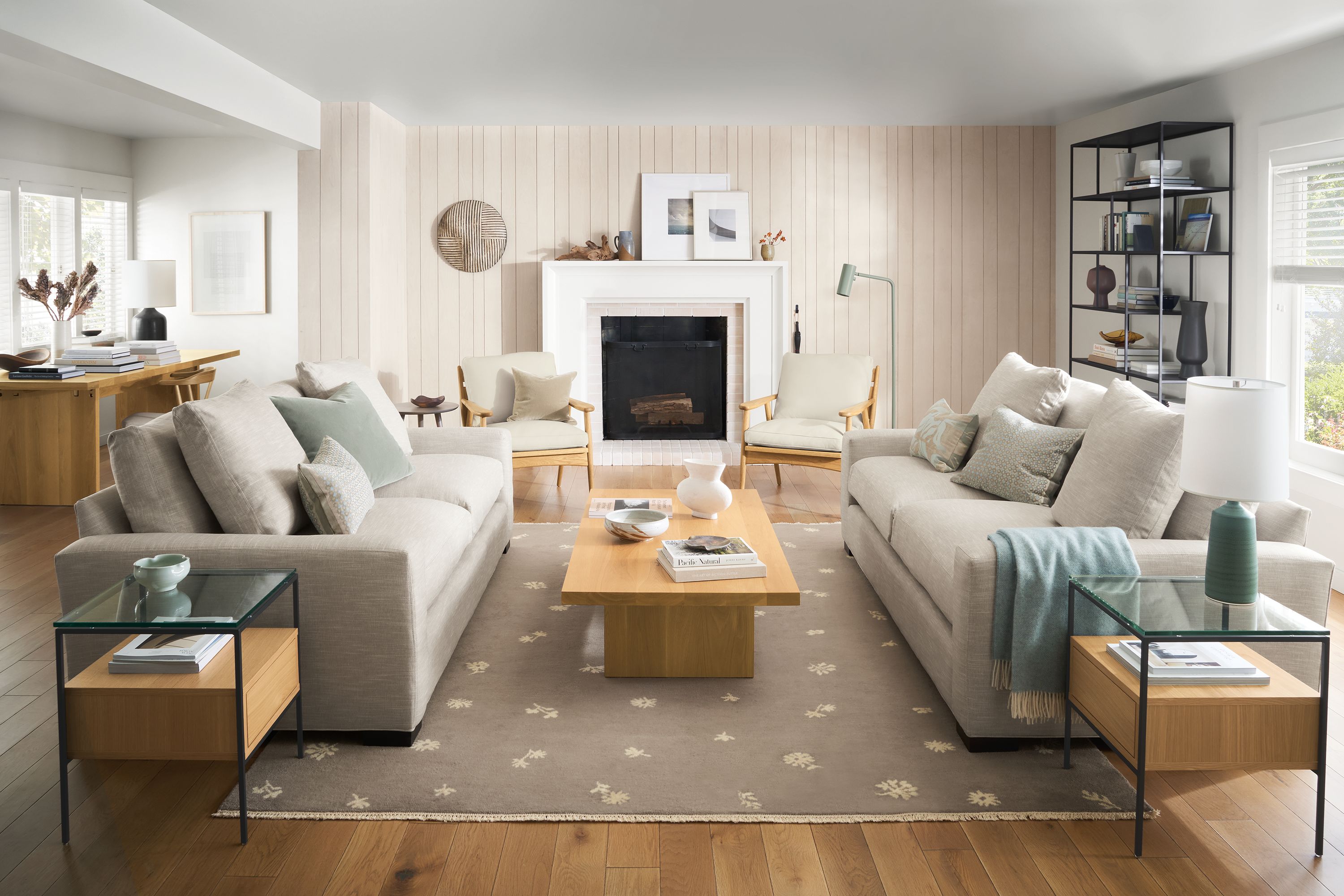 living room with fireplace, ericson chairs, metro sofas, tansy rug, corbett coffee table.