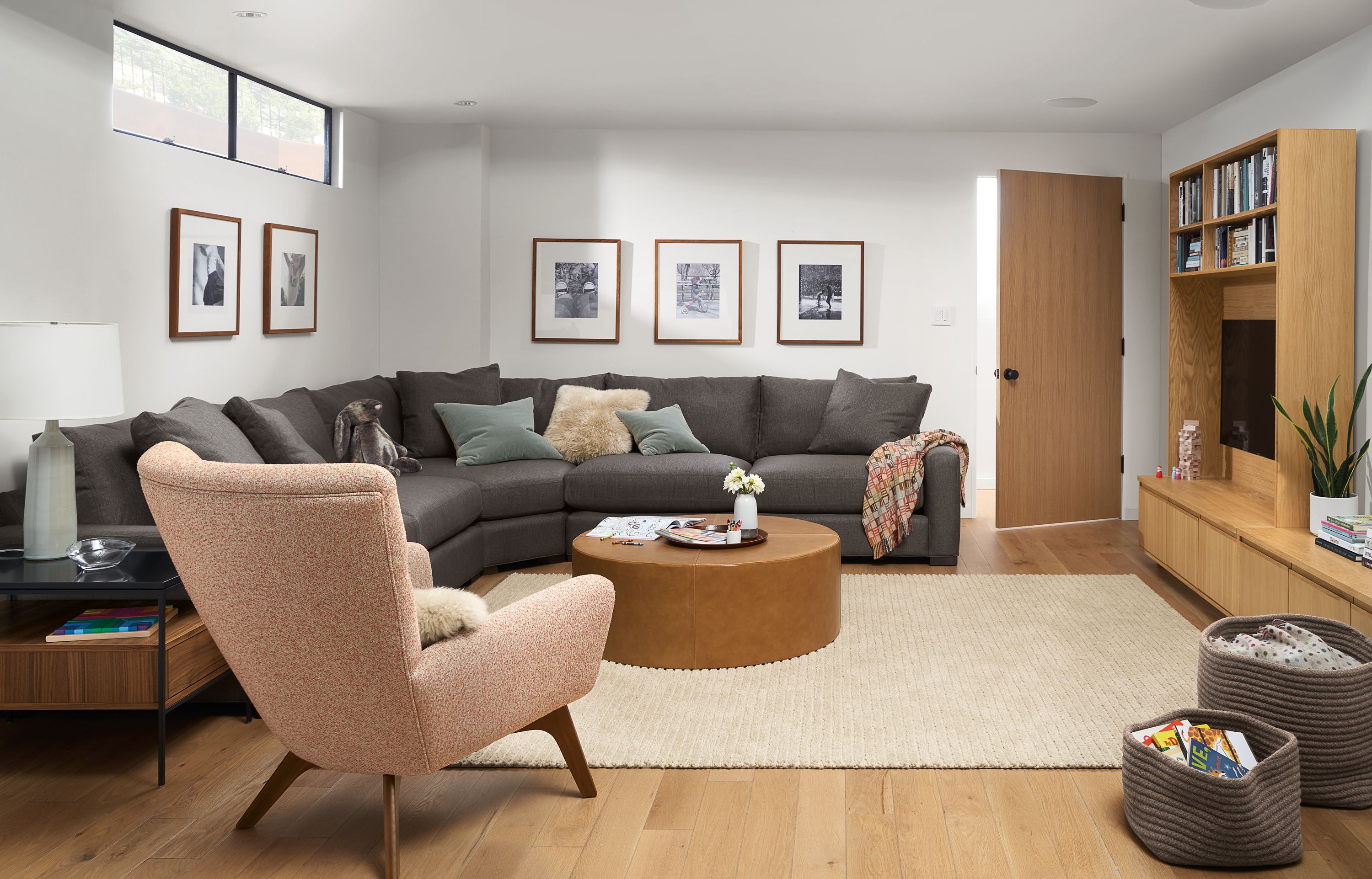 Room setting with Metro Extra Deep Three-Piece Sectional in Gino Fabric and Aero 42-round ottoman in leather.