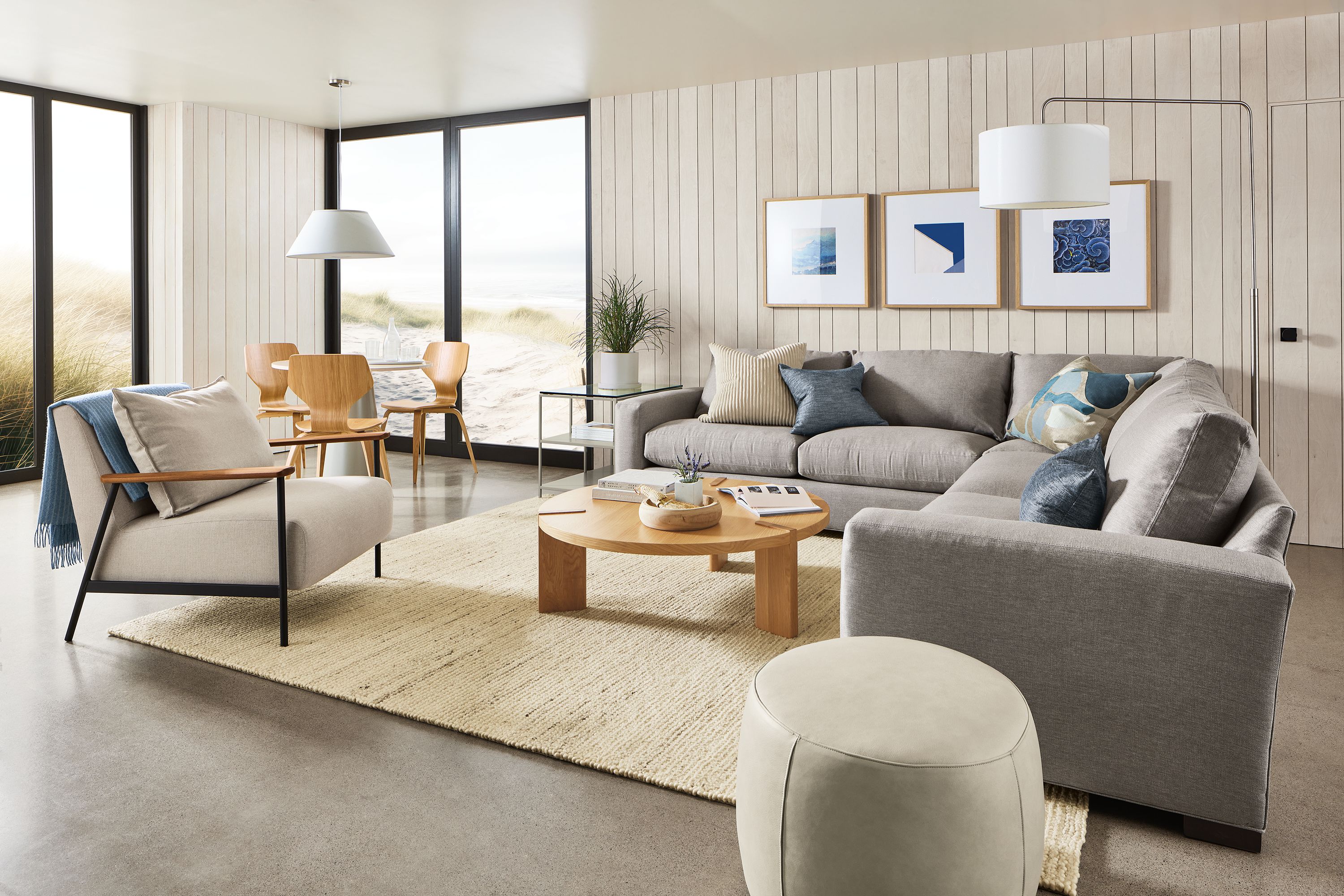 living room with metro sectional, xavier chair, three profile frames.