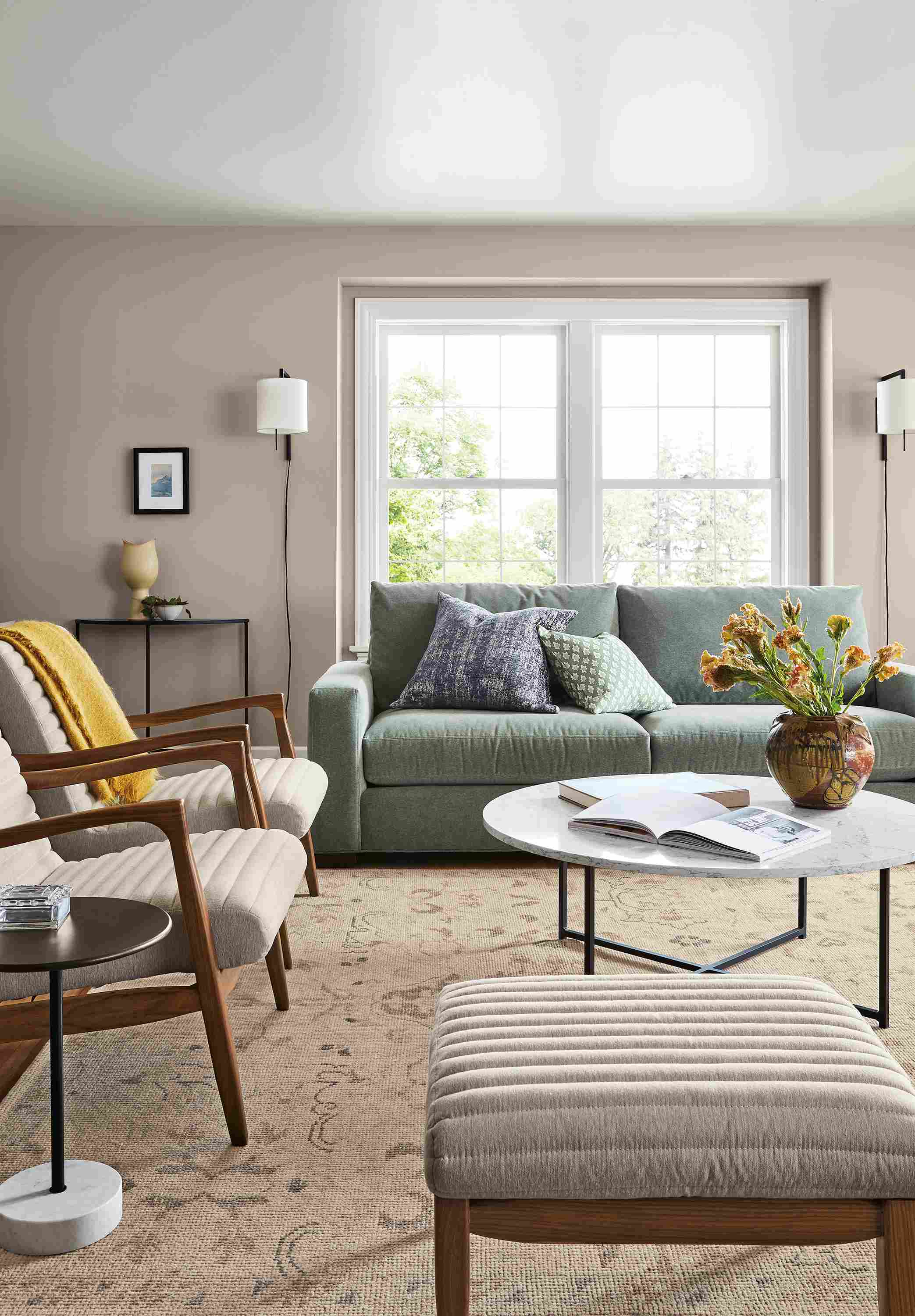 Living room with Metro sofa in Vick Lead, 2 Callan chairs and ottomans in Flint Oatmeal and Ophelia rug in Pumice.