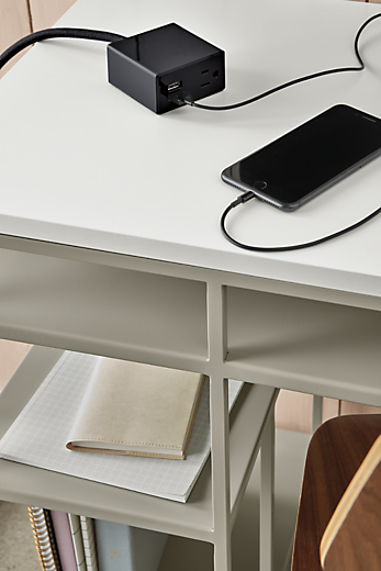 Close-up of a Miki Tabletop Power & Charging Outlet in Black on top of a Bowen 36-wide desk.  