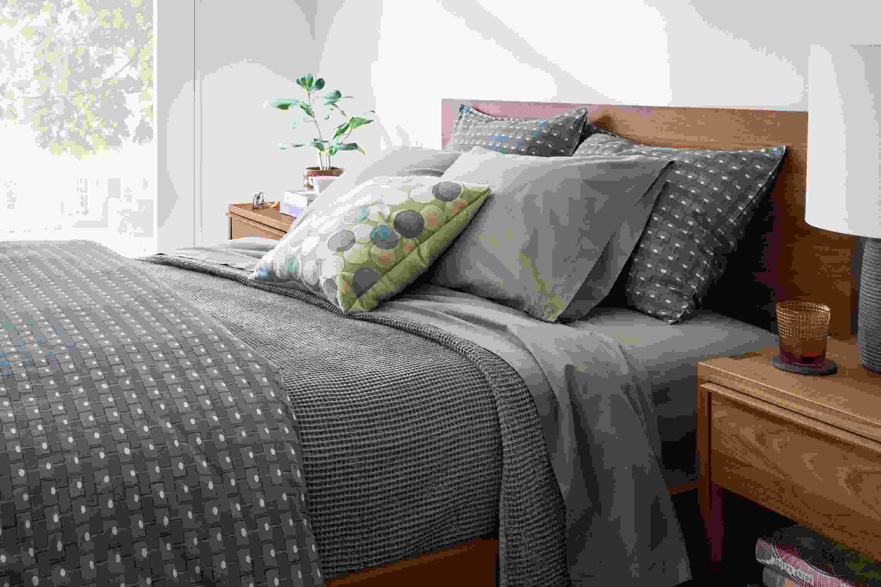 Bedroom with Milan duvet set in olive, Loren coverlet in charcoal and soft-washed percale sheet set in moss.