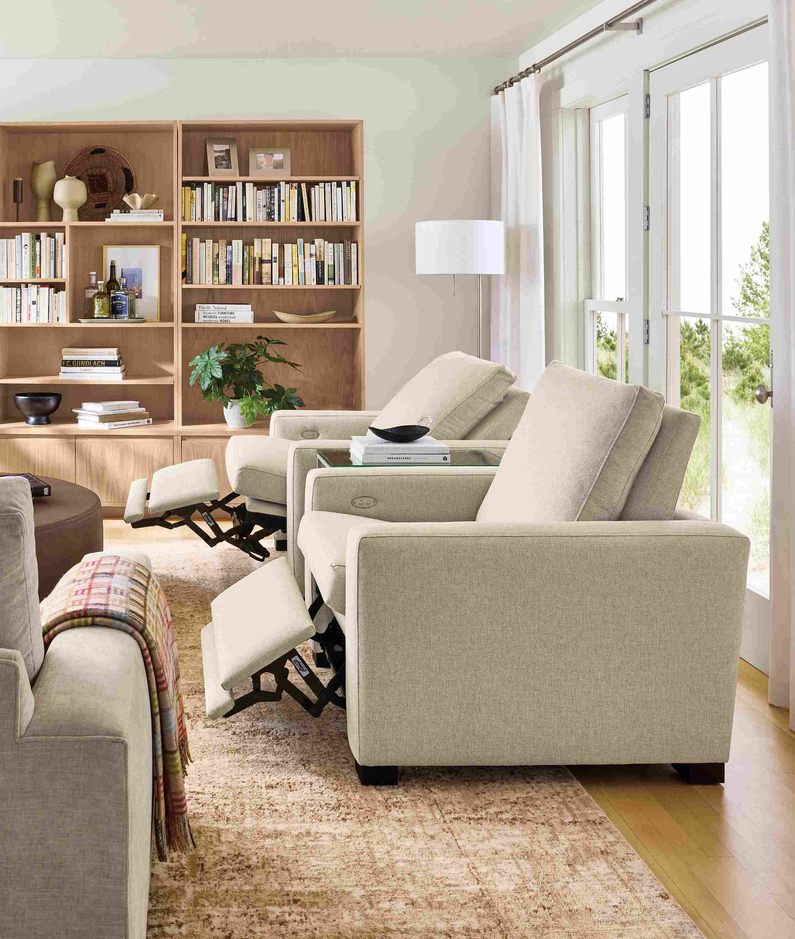 Living room with 2 milton power recliners in sumner linen shown with footrests extended.
