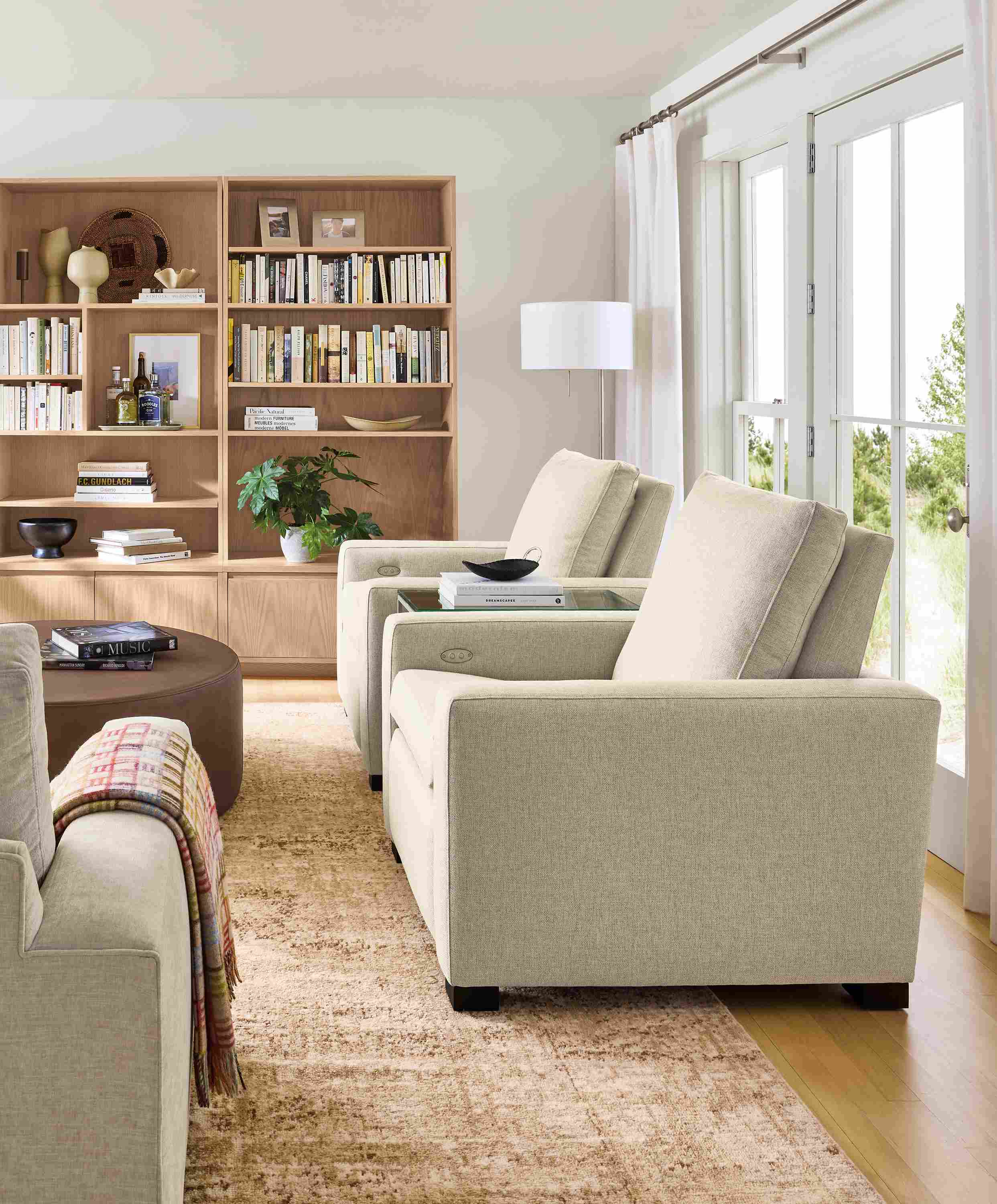 Living room with 2 milton power recliners in sumner linen and keaton 98-wide wall unit is salt on red oak.