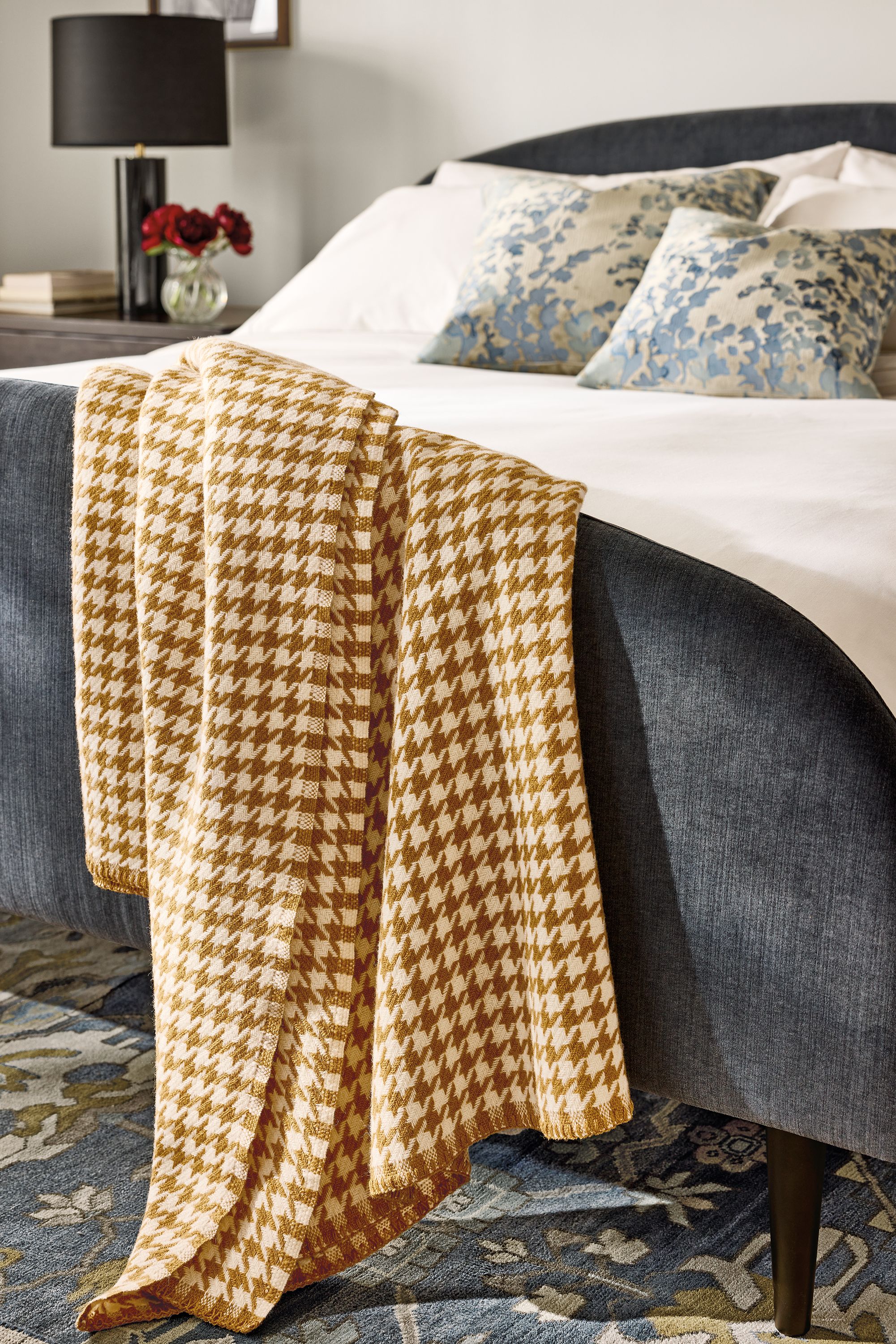 Bedroom with detail of Mimi throw blanket in tobacco, Amelia king bed in windsor navy and Fleur pillows in blue.