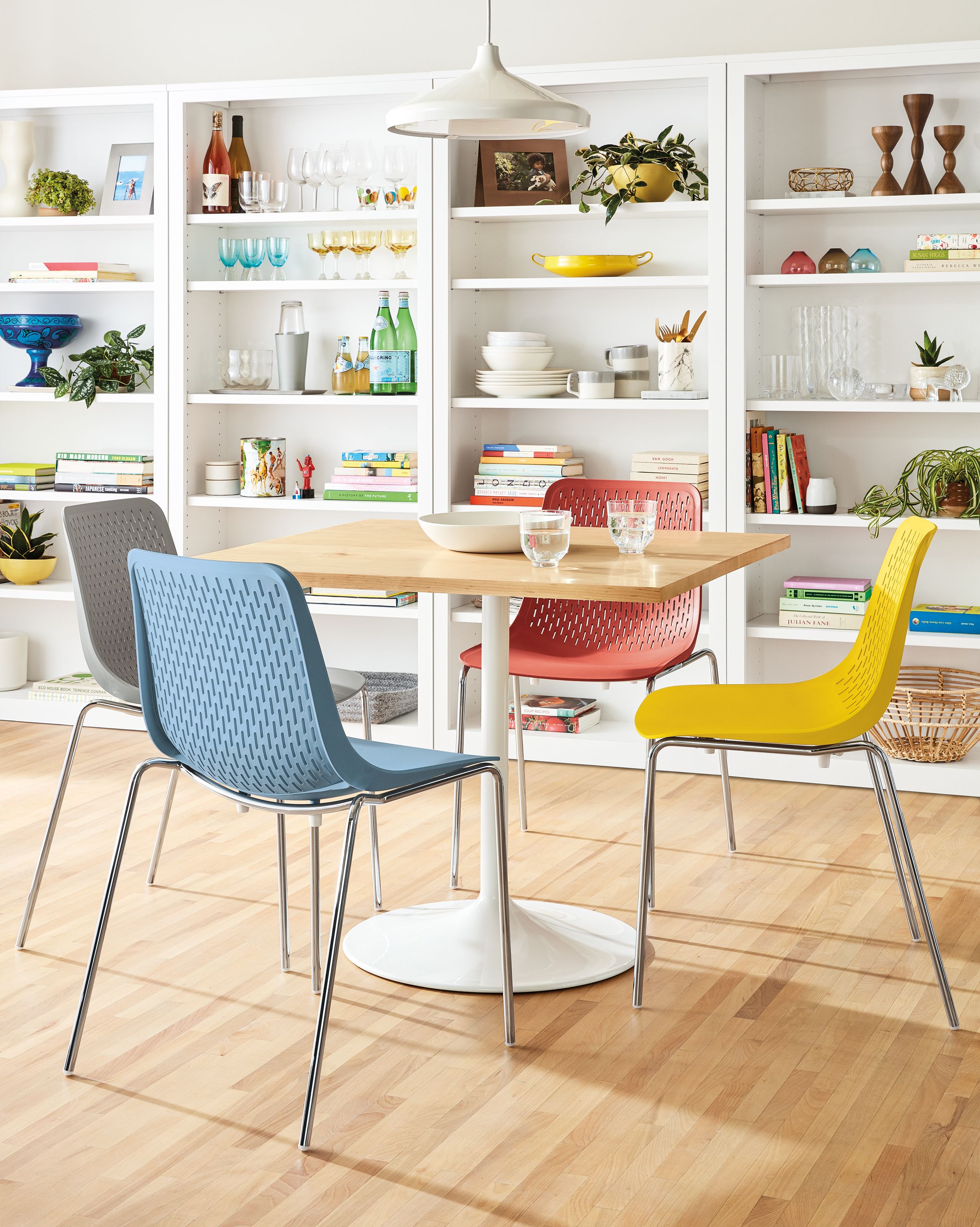 Detail of 4 Mini Rain side chairs in multiple colors set at Aria table.