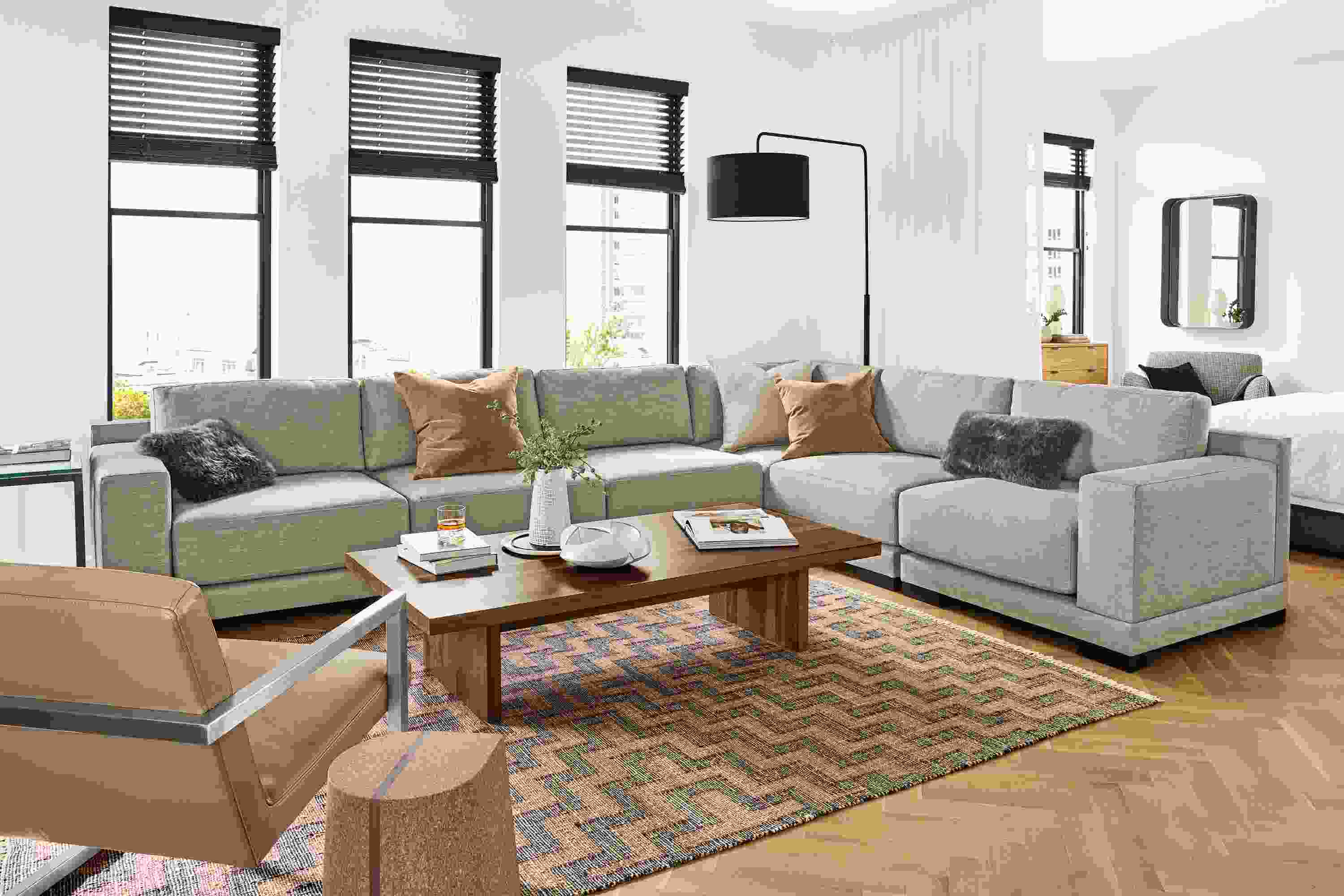 Detail of large Mira sectional in Destin Putty fabric in open apartment.