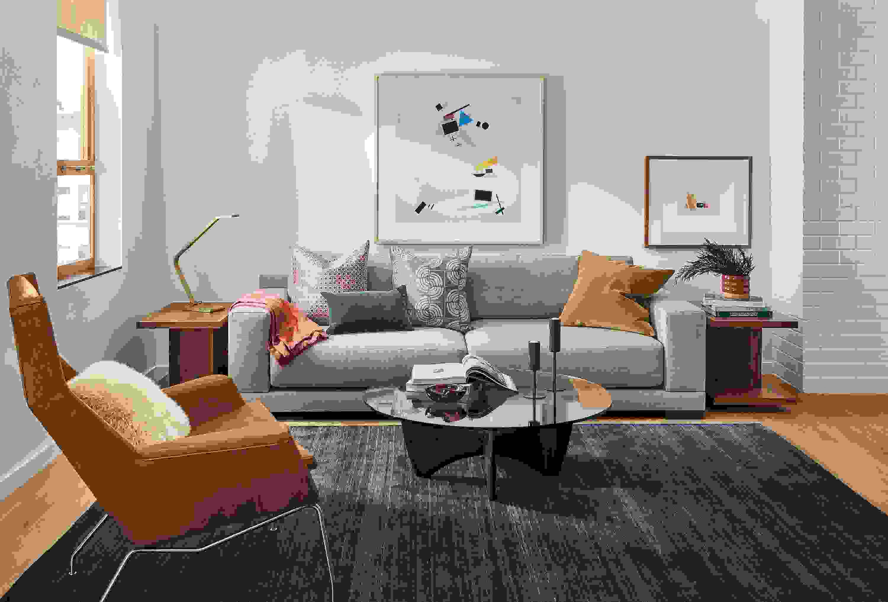 Room setting with a Mira Deep 100-wide sofa in Destin Fabric, an Aidan Chair in Vento leather and a Sanders coffee table.