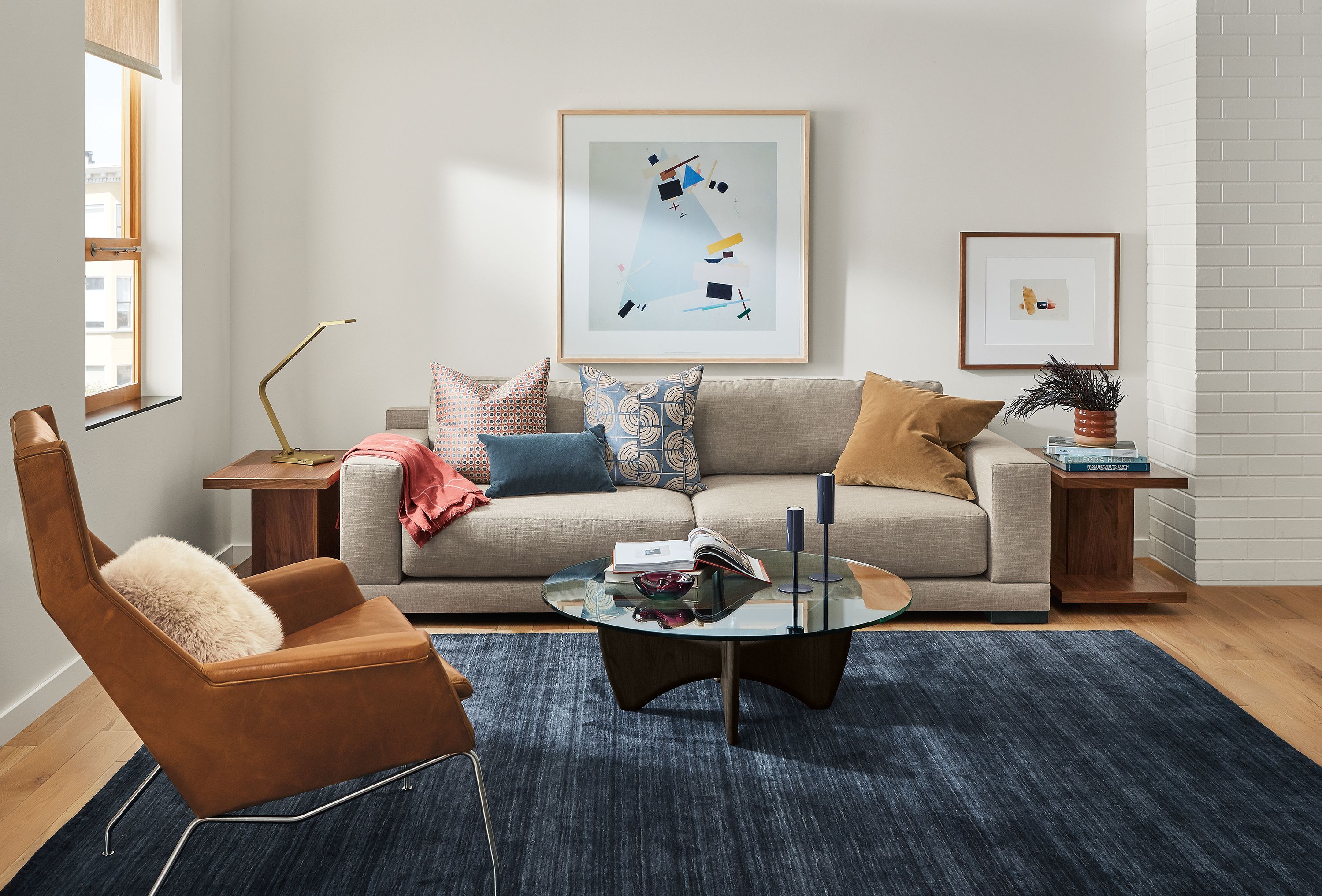 Room setting with a Mira Deep 100-wide sofa in Destin Fabric, an Aidan Chair in Vento leather and a Sanders coffee table.