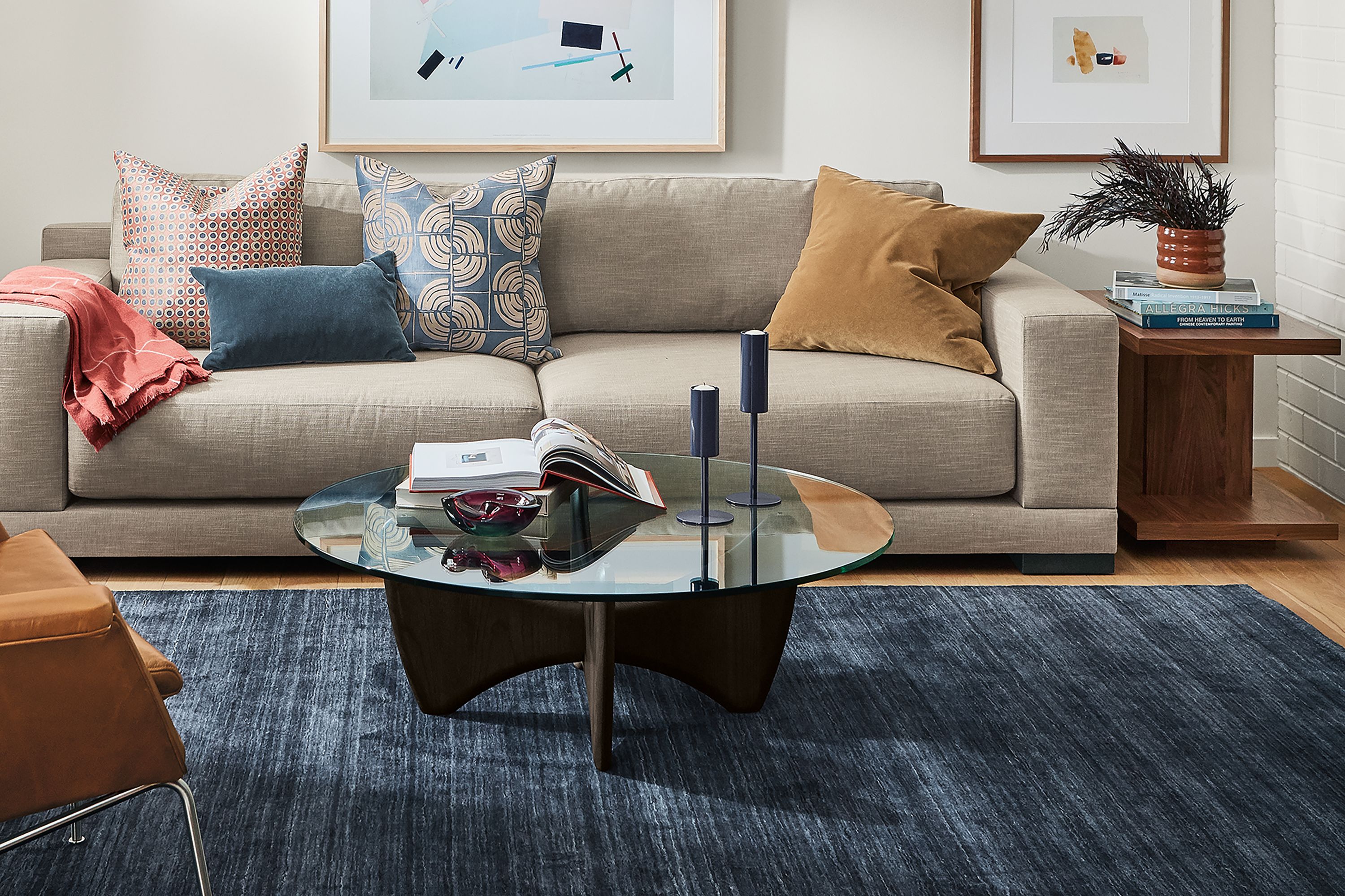 Room setting with a Mira Deep 100-wide sofa in Destin Fabric, an Aidan Chair in Vento leather and a Sanders coffee table.