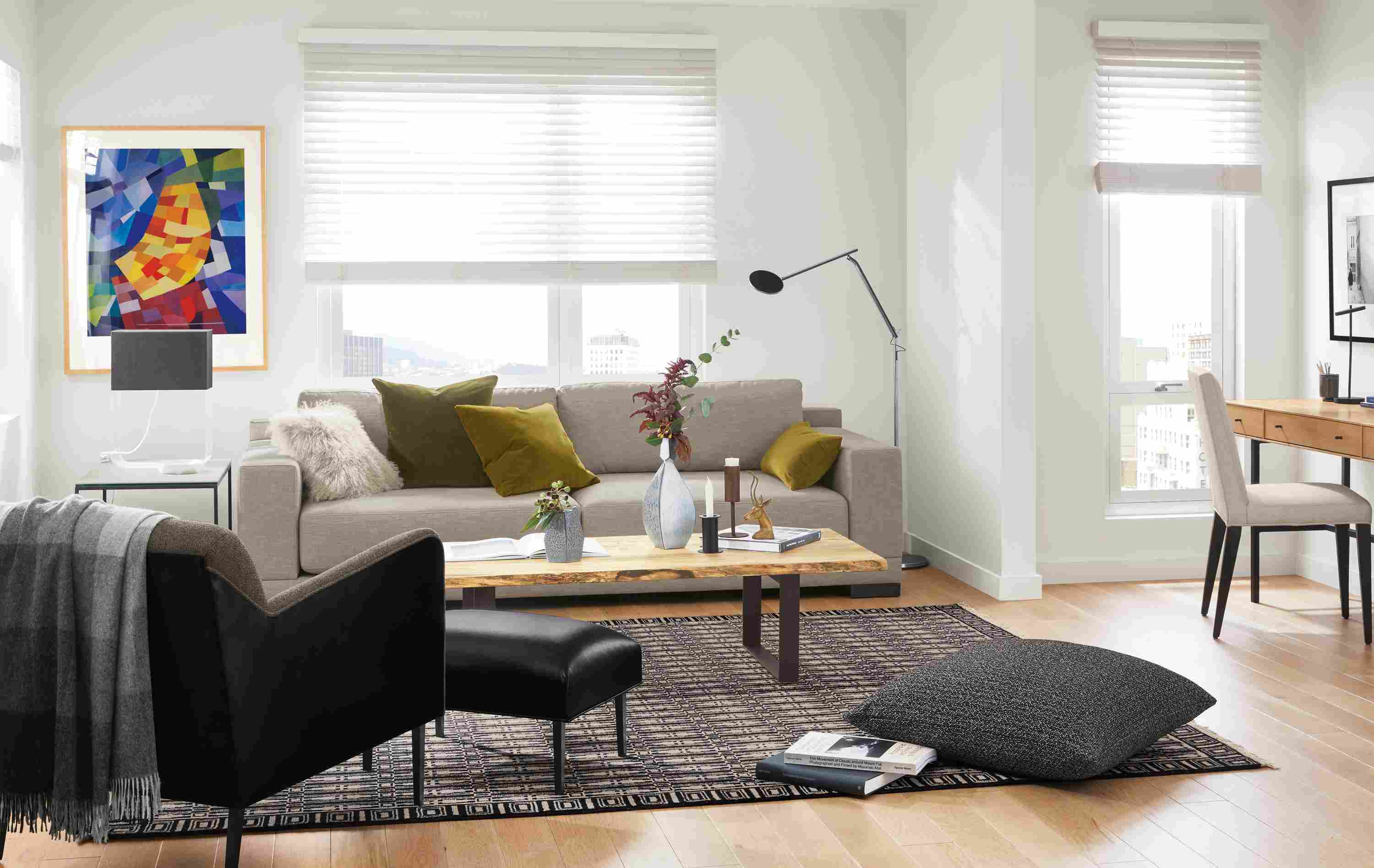 Detail of Mira extra deep sofa in Destin Putty fabric in small apartment living room with desk.