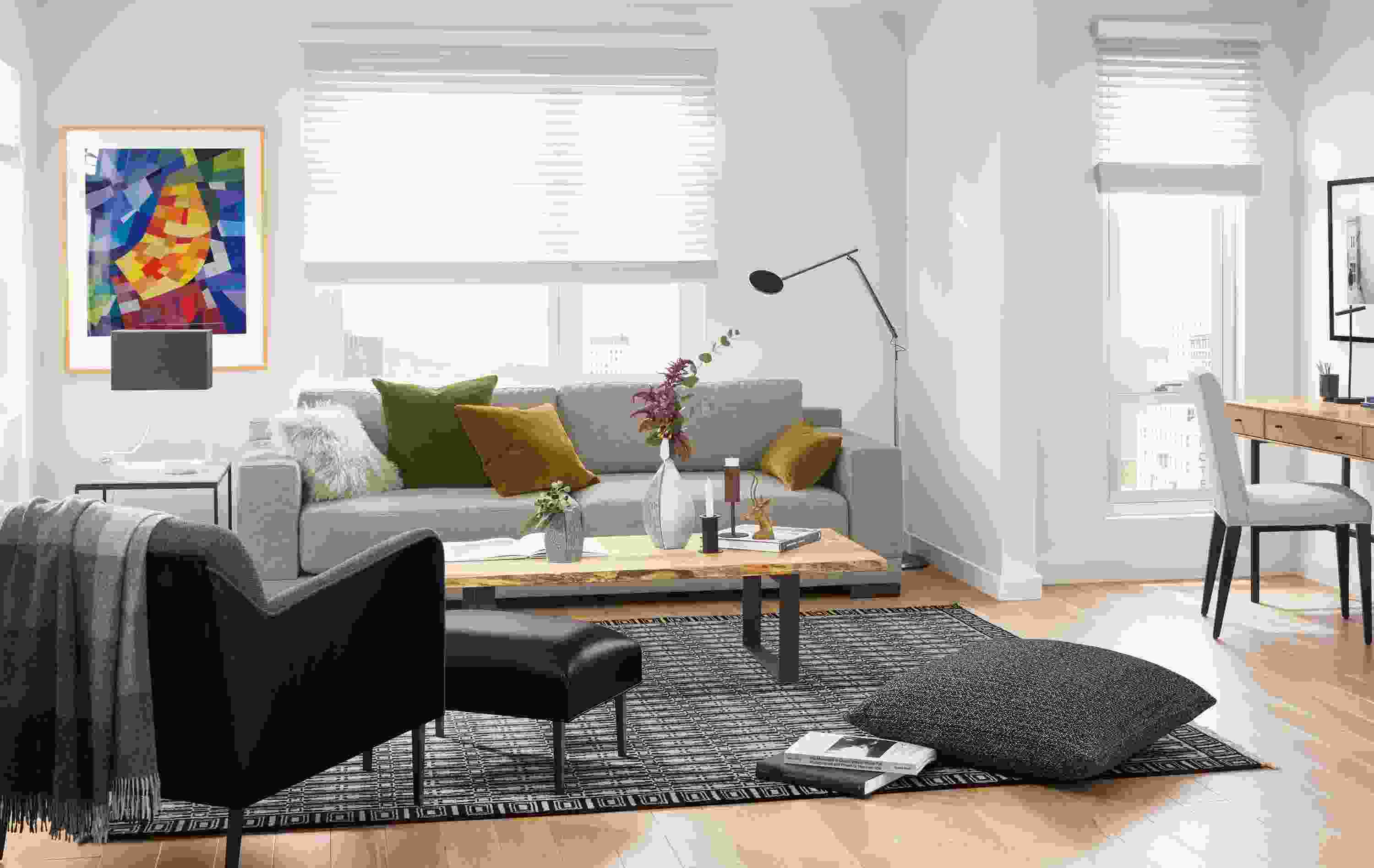 Detail of Mira extra deep sofa in Destin Putty fabric in small apartment living room with desk.