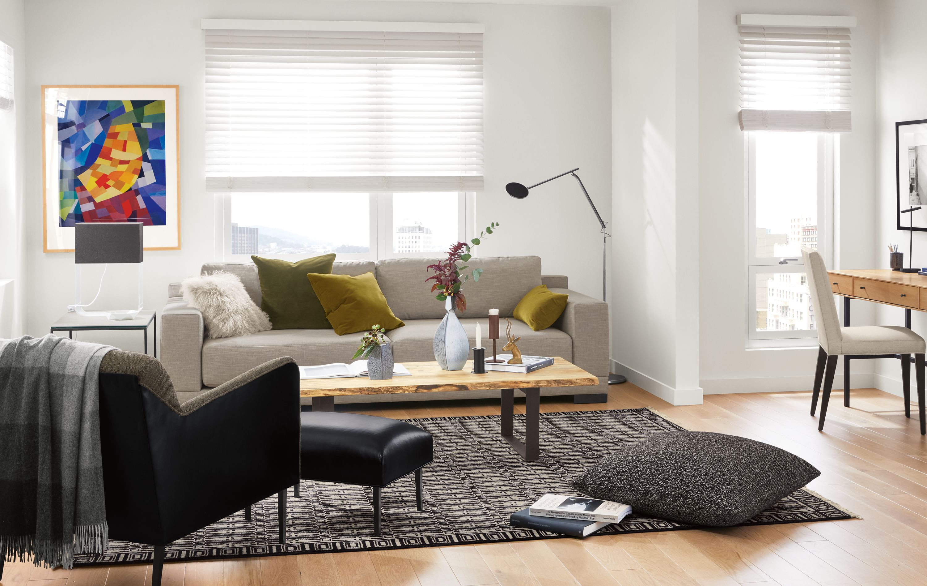 Detail of Mira extra deep sofa in Destin Putty fabric in small apartment living room with desk.