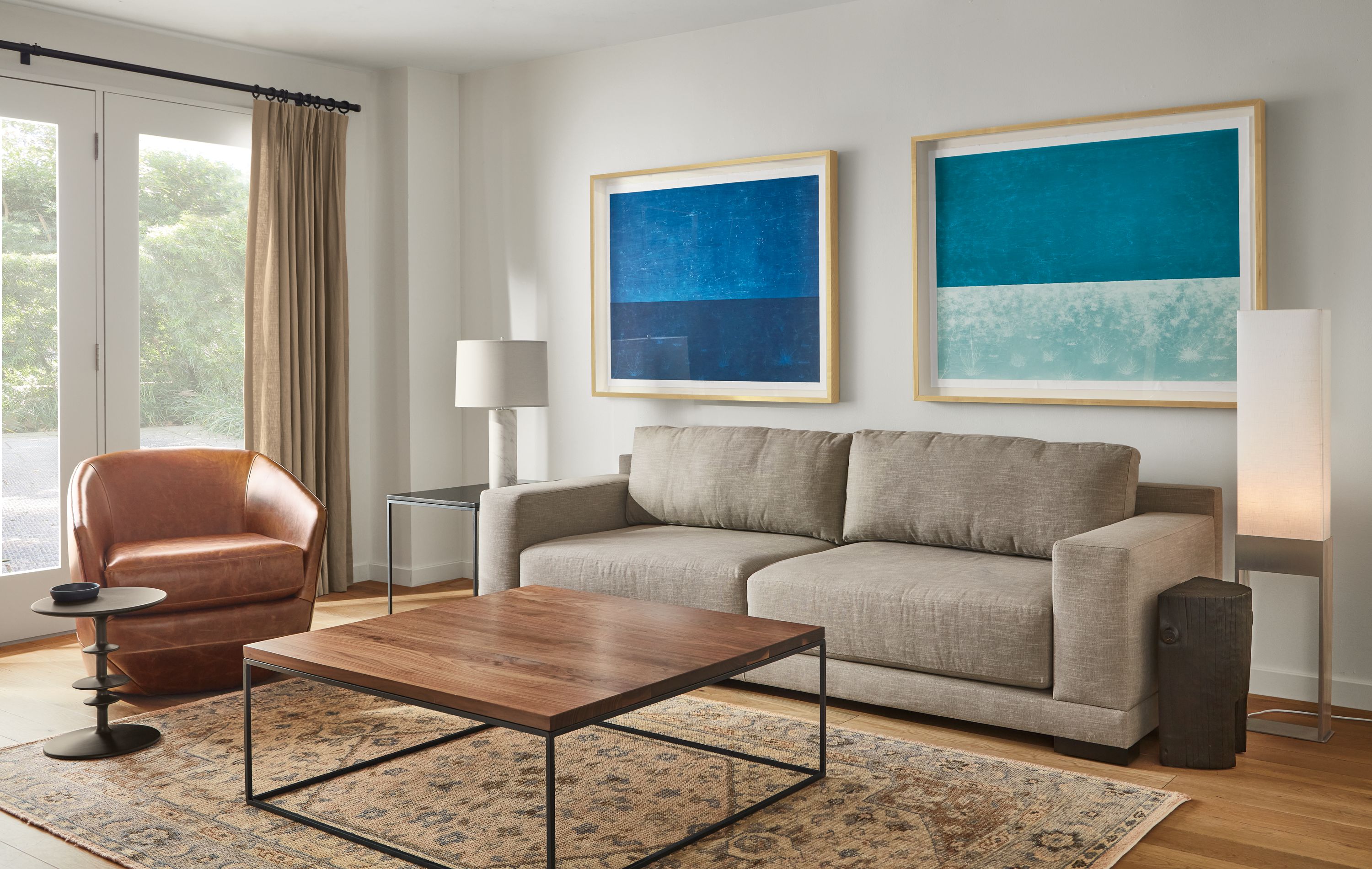 Mira 96-wide sofa in Destin Fabric, Tyne 40-square coffee table in Walnut and Natural Steel and Veda rug in Camel.