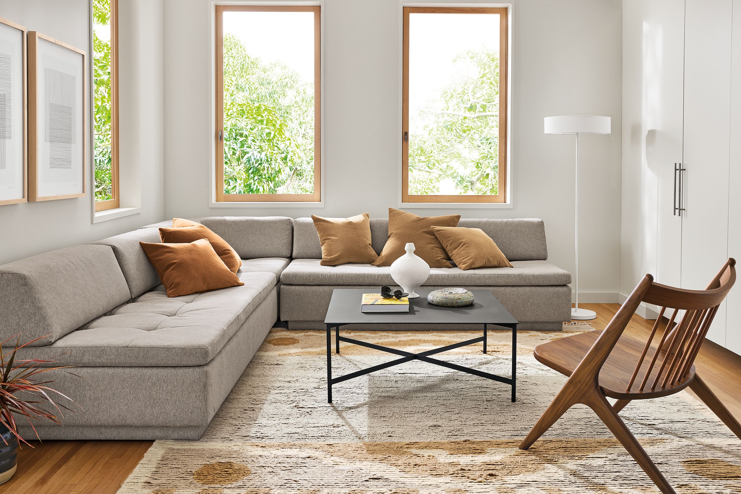 Living area with Miranda Sectional in Elin Cement fabric, Circuit coffee table, Oskar chair in walnut and Tova rug in sand.