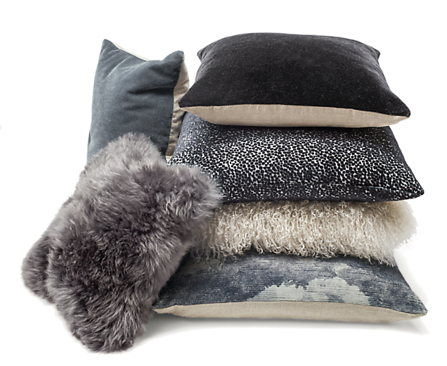Stack of throw pillows in steel grey ensemble.