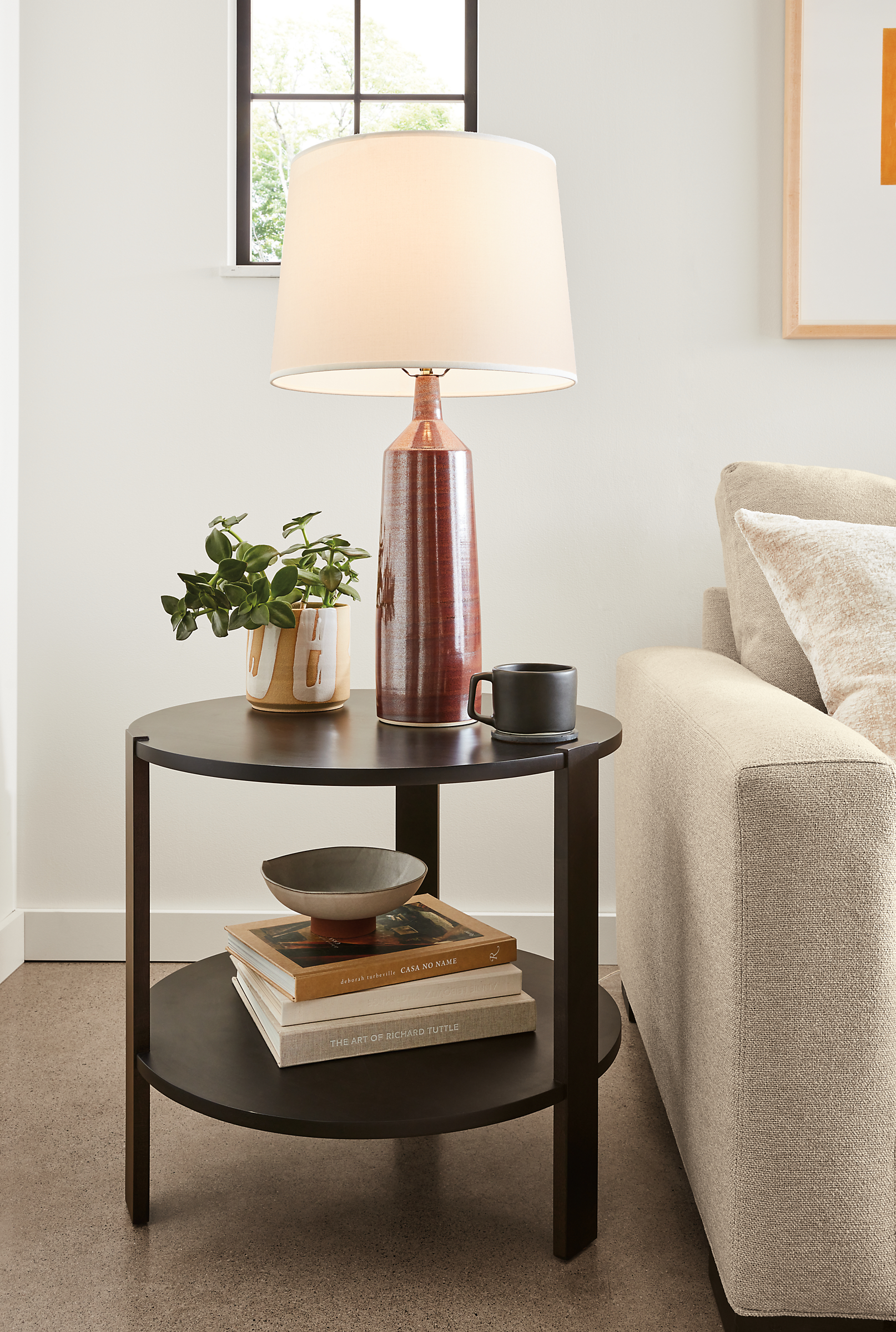 Greene 24-round end table in Charcoal with a Monarch table lamp.
