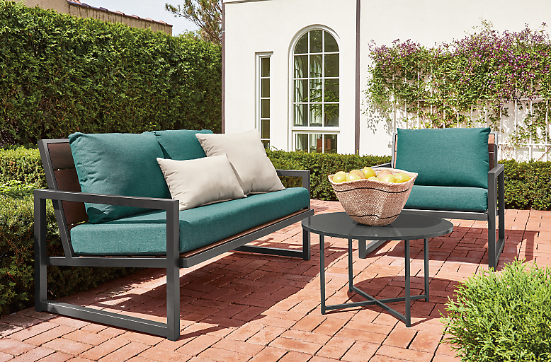Outdoor patio setting with a Montego 57-wide sofa and Montego 32-wide lounge chair with cushion in Pelham Fabric.