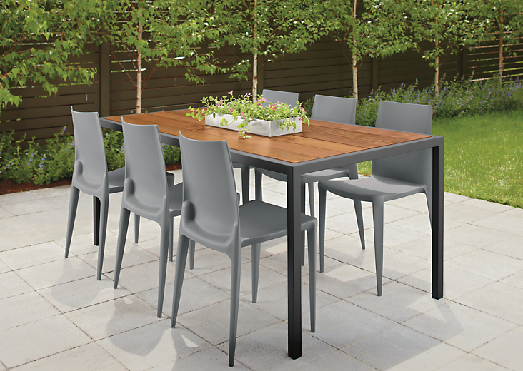 Outdoor patio setting with a Montego 72-wide Dining Table in Graphite and six Bellini chairs in Black.  