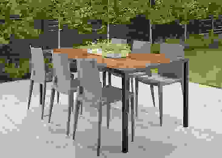 Outdoor patio setting with a Montego 72-wide Dining Table in Graphite and six Bellini chairs in Black.  