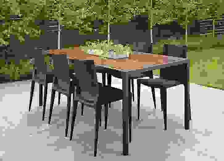 Outdoor patio setting with a Montego 72-wide Dining Table in Graphite and six Bellini chairs in Black.