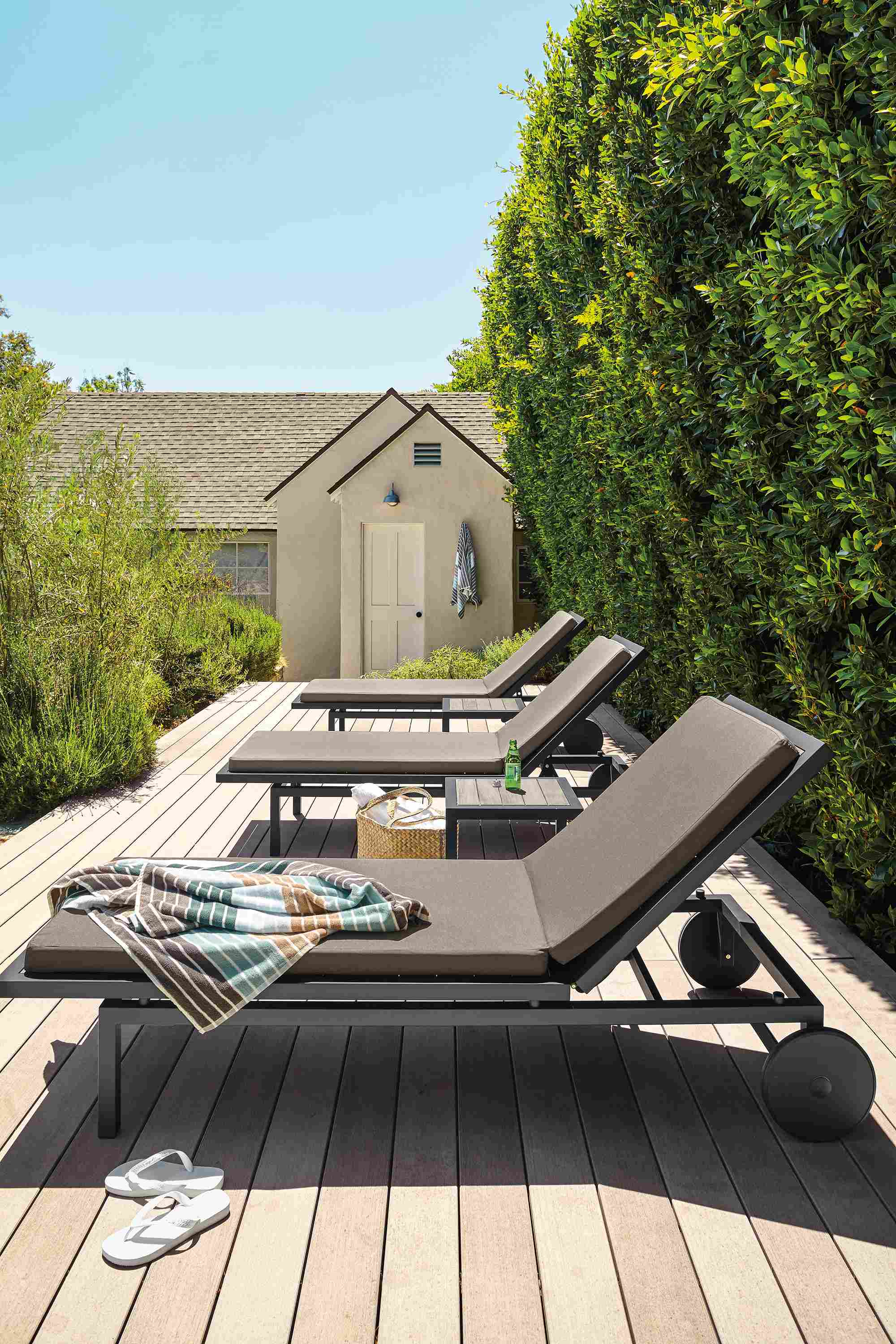 Sunny deck with 3 Montego chaises in reclaimed ash and graphite with Pelham Cement cushions.