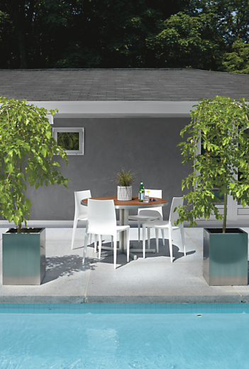Outdoor pool setting with Montego 48-round Dining Table in Stainless Steel with four Bellini Chairs in White.  