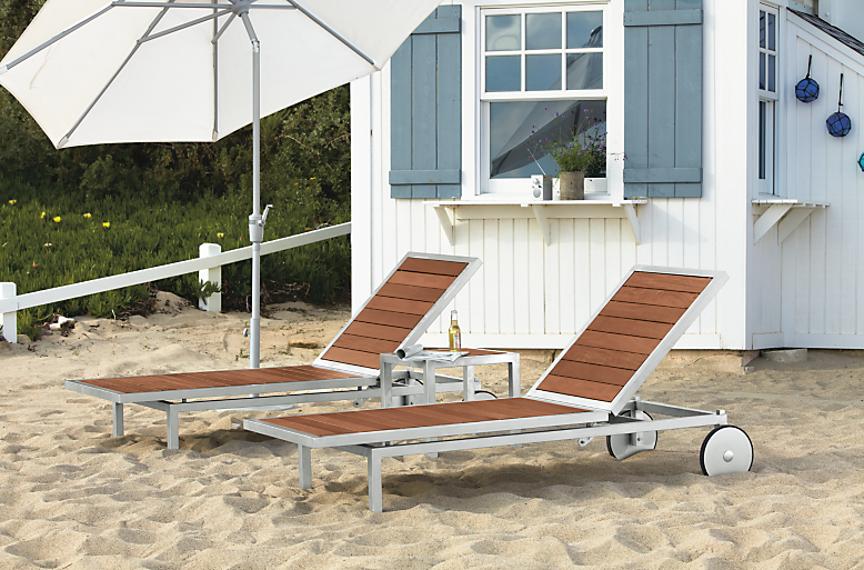 Outdoor beach setting with two Montego Chaises in Stainless Steel and Maui umbrella with freestanding base.