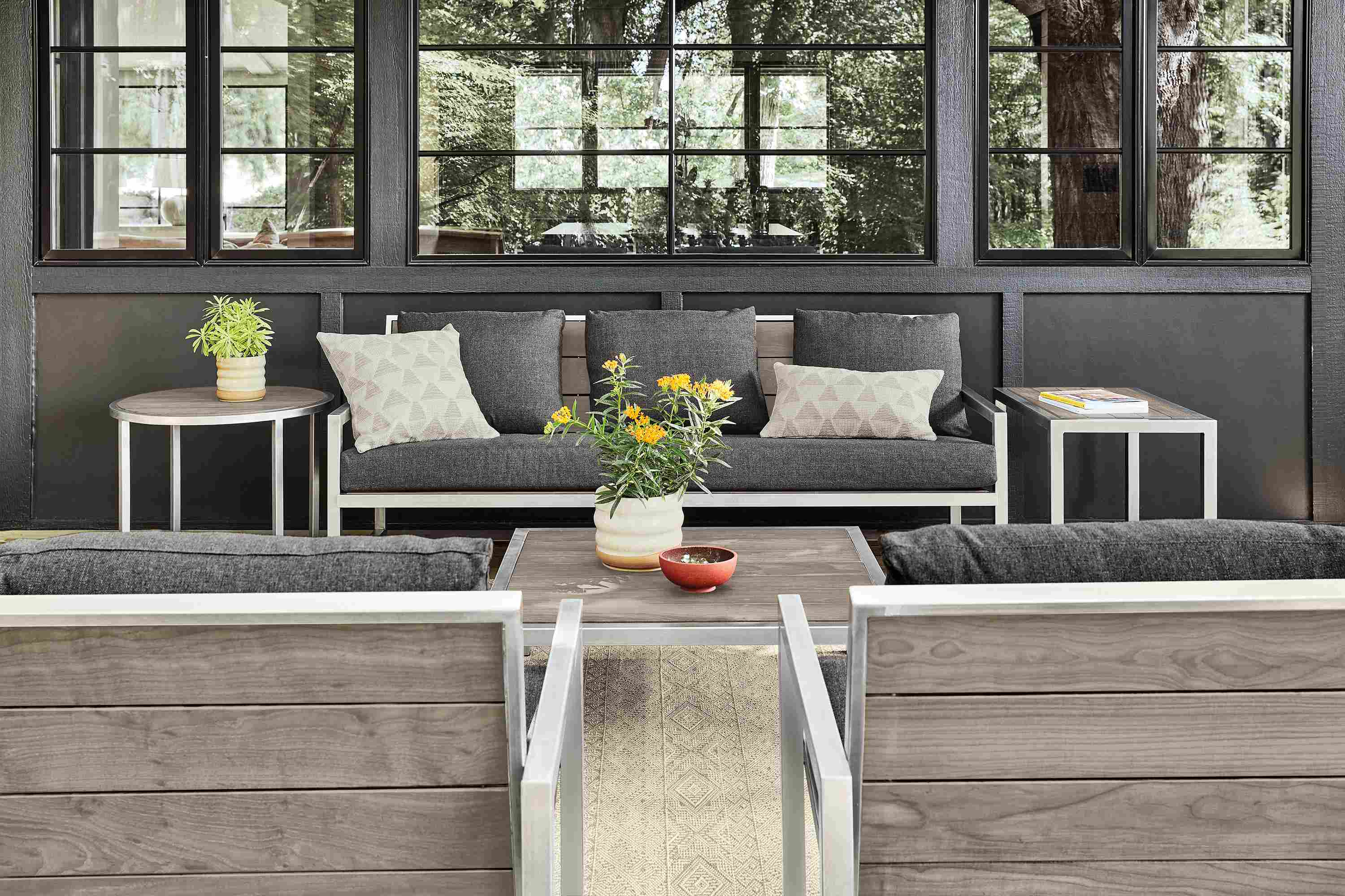 Montego sofa with Mist charcoal cushions, coffee table and two end tables in stainless steel with aged Thermally modified ash wood.