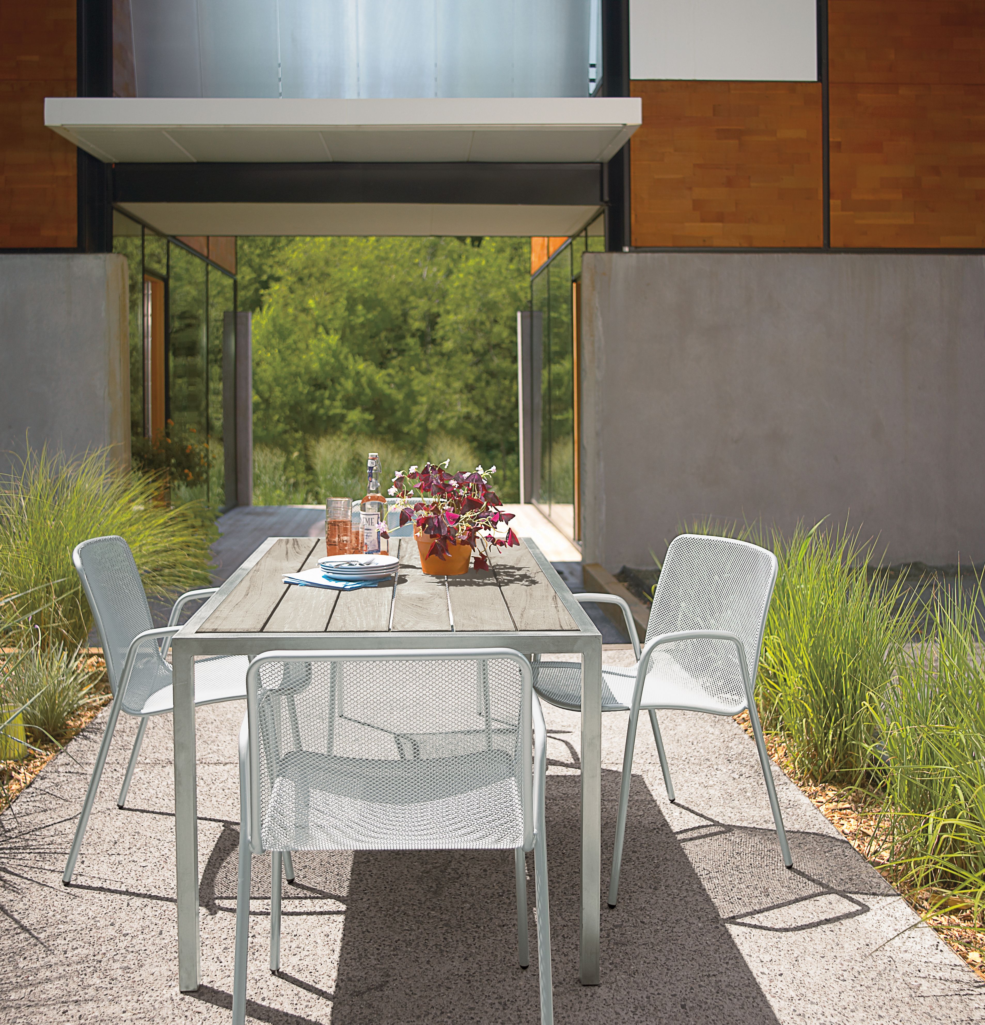 brick patio with montego sofa and 2 montego lounge chairs in aged ash.