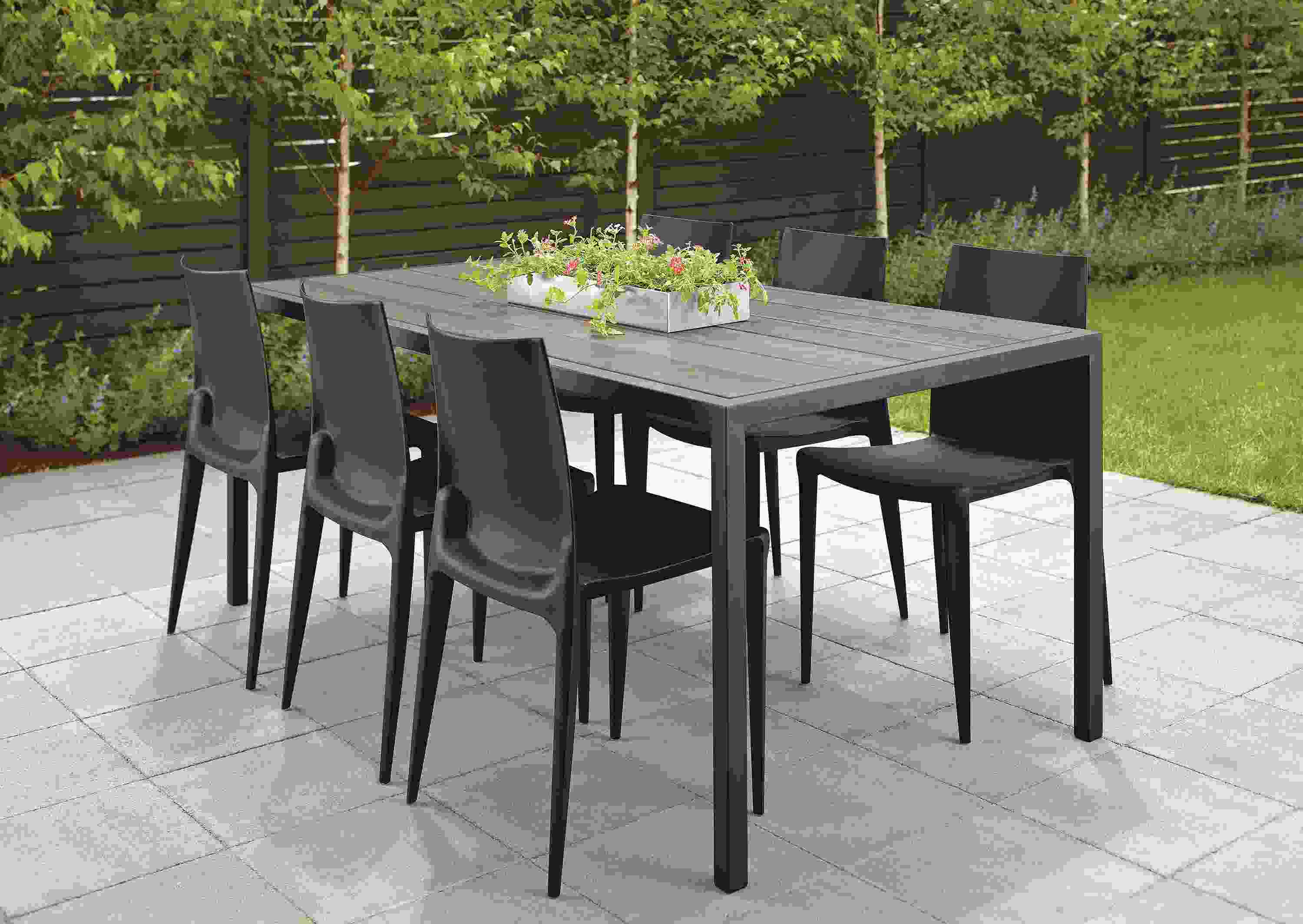 Patio with Montego 72-wide table in graphite and aged reclaimed oak and graphite and 6 Bellini chairs in black.