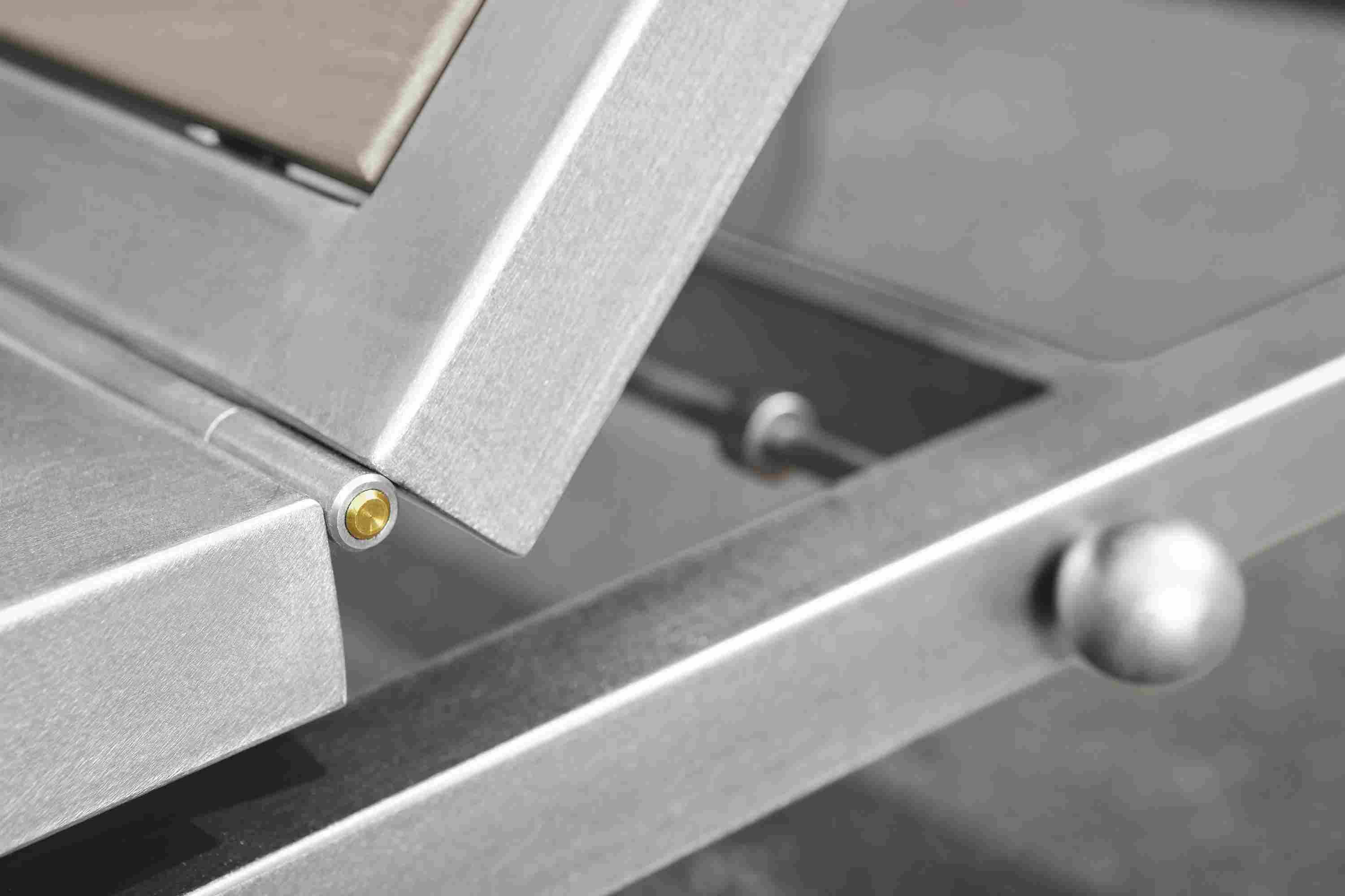 Detail of hinge mechanism on a Montego chaise lounge chair in stainless steel.