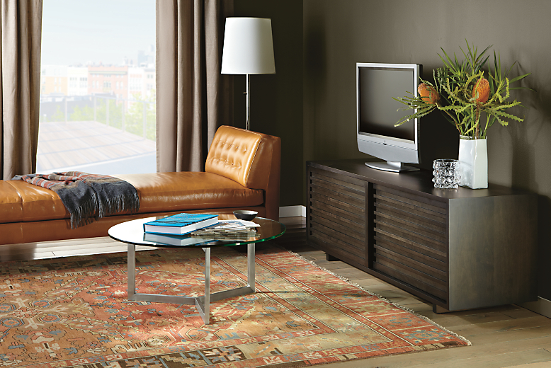 Room setting with a Moro 72-wide Two-Door Media Cabinet in Charcoal and Bond 36-round coffee table.   
