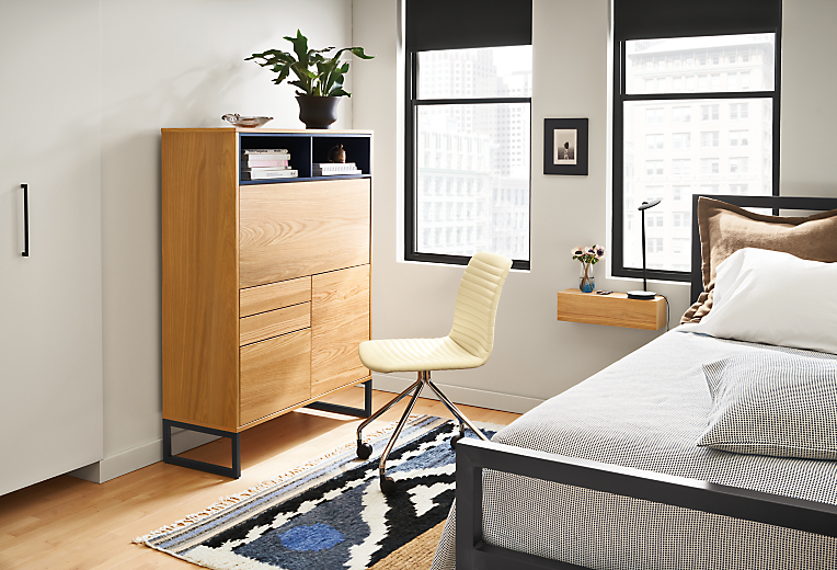 Room setting with a Mosby 40 Office Armoire and Cato Office Chair in Synthetic Leather with a Parsons Queen Bed.