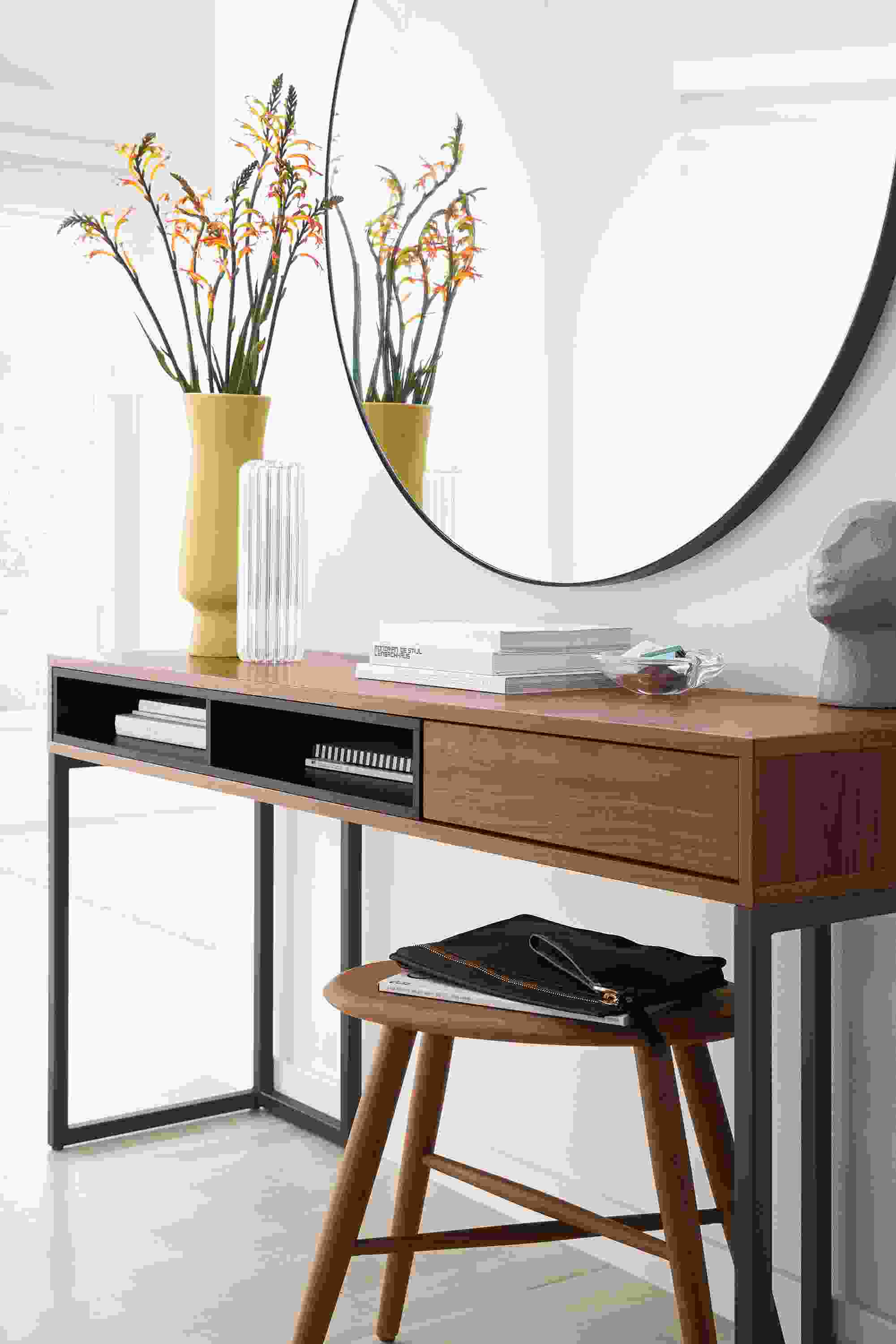 Room setting with a Mosby 60-wide Desk and a Dell Stool in Walnut, with an 
Infinity 46 diam 2d Round Mirror in Graphite.