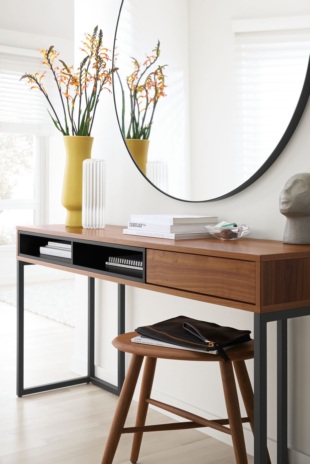 Room setting with a Mosby 60-wide Desk and a Dell Stool in Walnut, with an 
Infinity 46 diam 2d Round Mirror in Graphite.